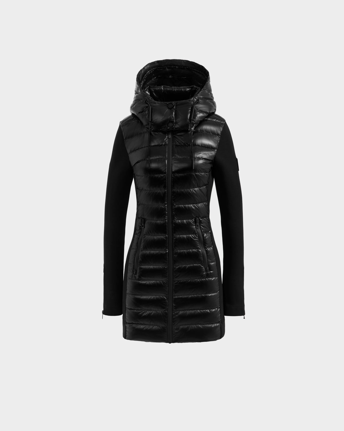The Rudsak MERINA C - 8125648 Black is a women’s mid-length jacket featuring a shiny quilted front, hood, and fitted sleeves, shown against a plain light gray background.