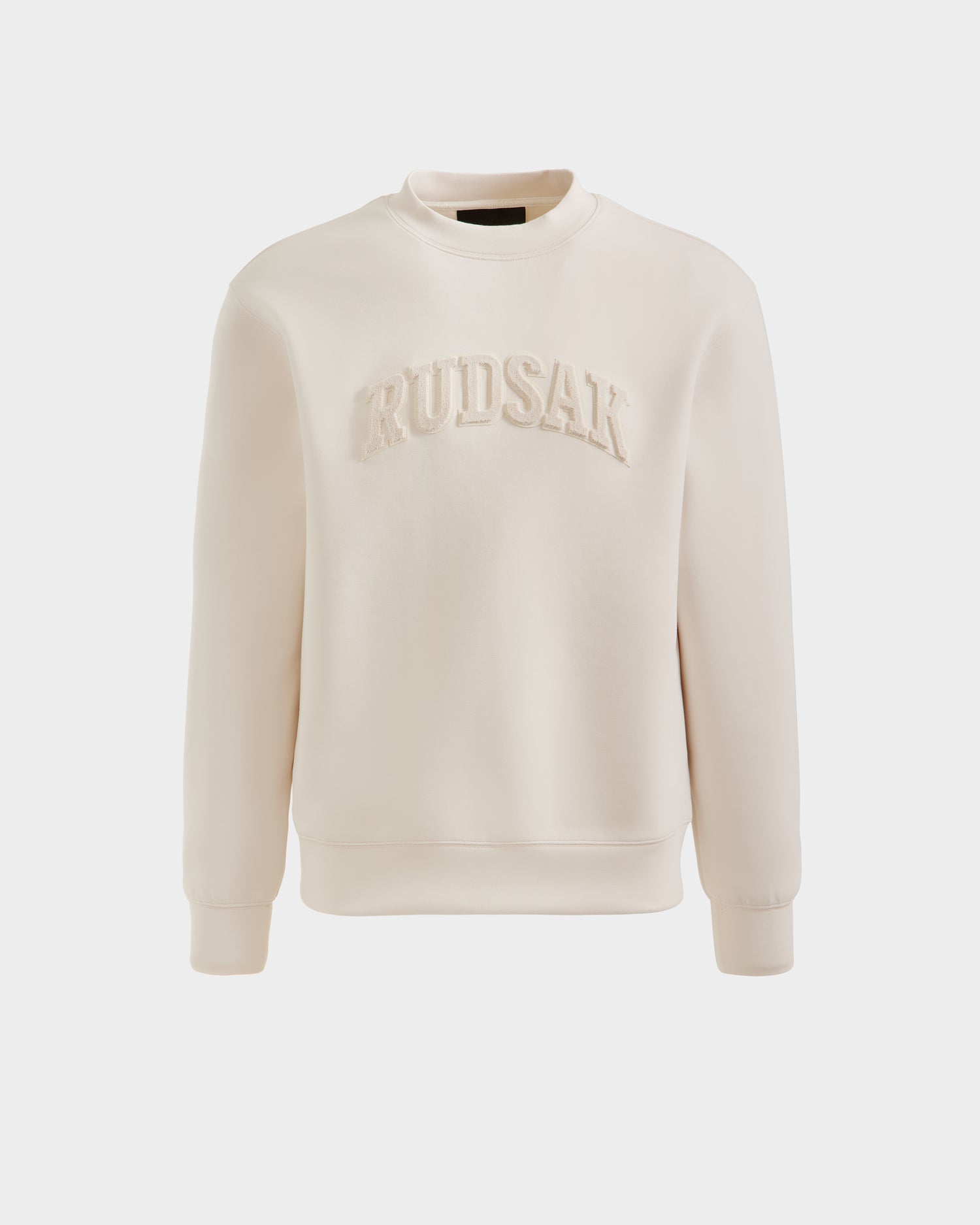 The MILOS - 6525646 Vanilla by Rudsak is a cream-colored men’s cotton-blend crewneck sweatshirt with large, raised RUDSAK embroidery across the chest, displayed against a plain white background.