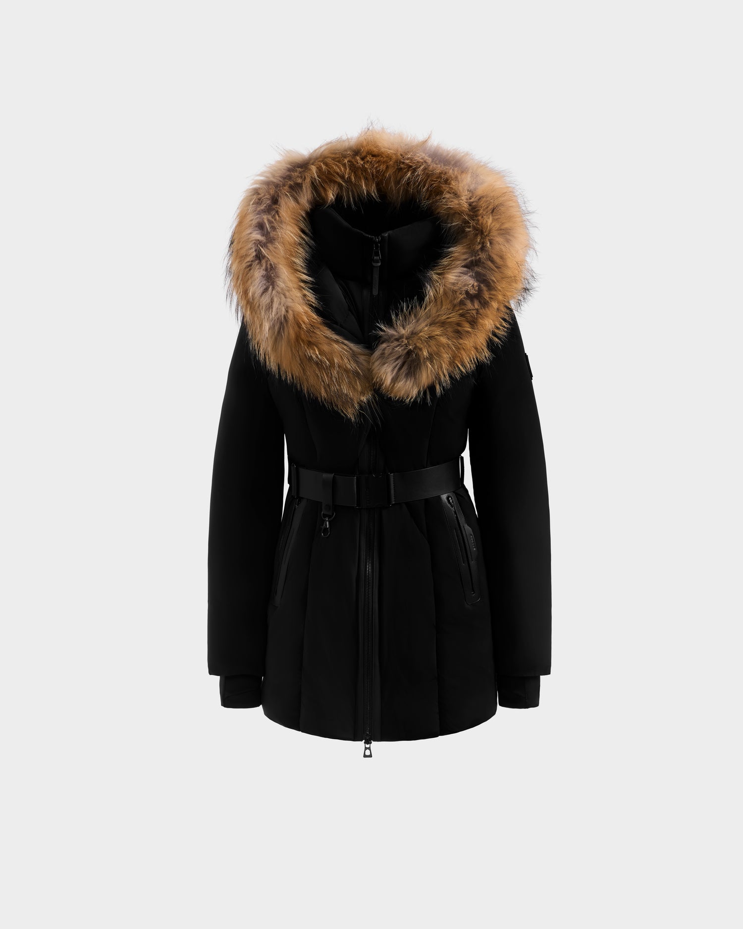 The Rudsak MODA - 8125704 Black/Natural parka features a belted waist, front zipper, and a large hood with brown faux fur trim, shown against a light gray background.