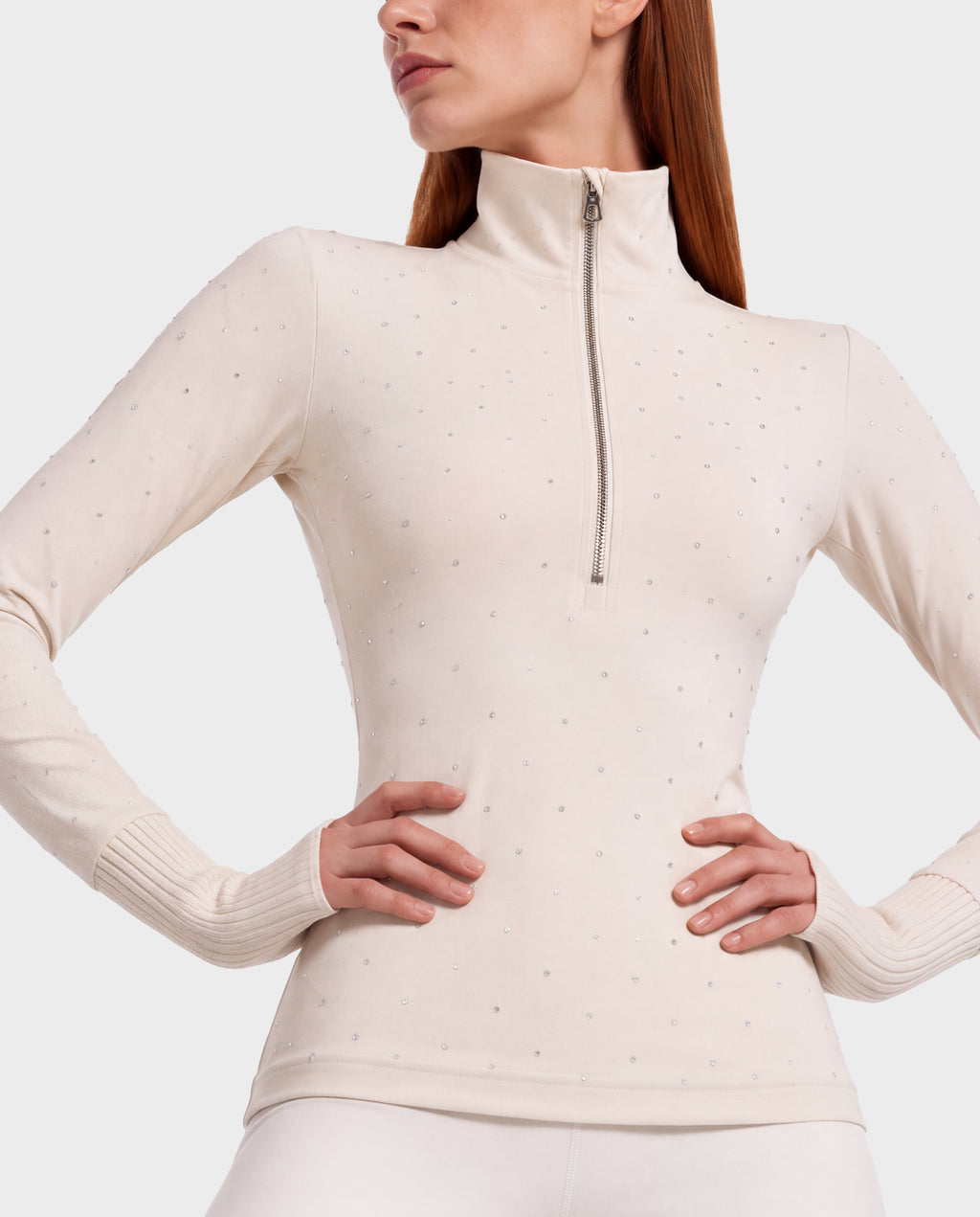 A cream-colored, stretch nylon NEVA - 8526524 Vanilla long-sleeved mock neck top featuring a front zipper and scattered rhinestone embellishments.