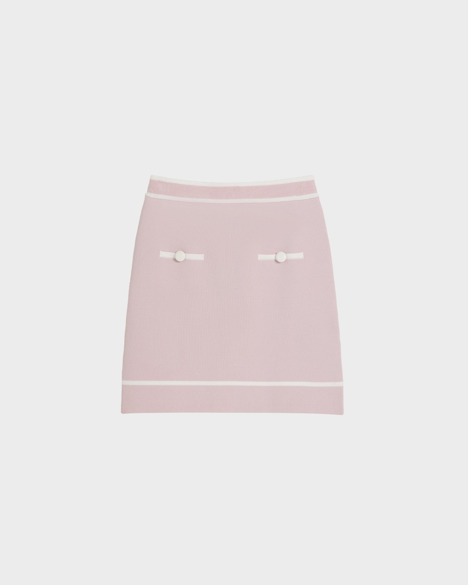 The Rudsak NAPA - 8525083 Light Pink skirt is a modern knee-length style with white trim at the waist and hem, two decorative white buttons, and horizontal white accents near the front pockets.