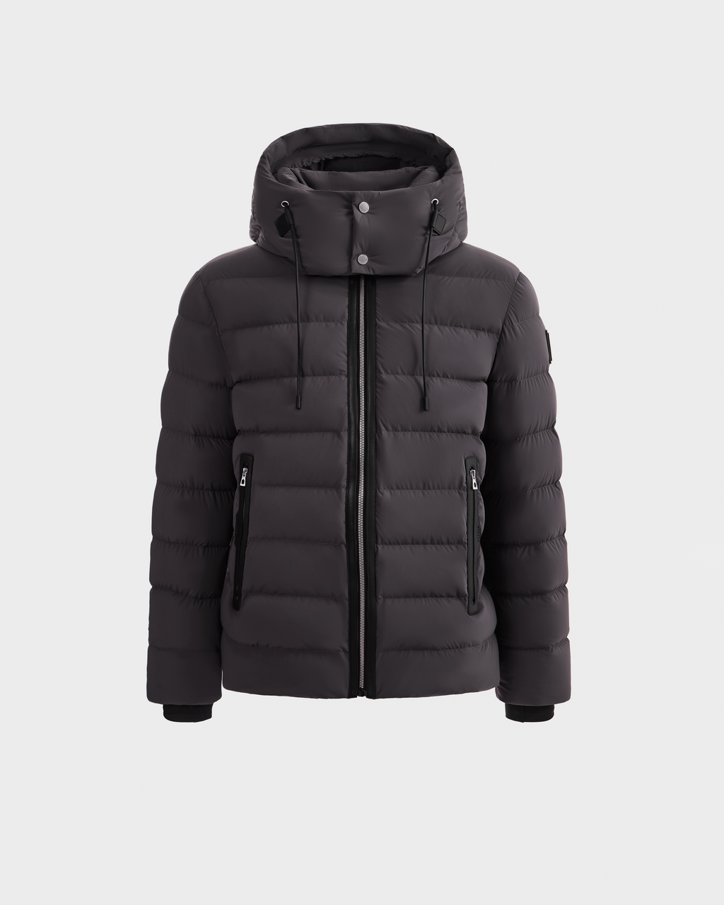 The Rudsak NAVAN - 6125598 Grey is a grey quilted puffer jacket with a hood, front zipper, and two zippered side pockets, made with RDS-certified down, shown against a plain white background.