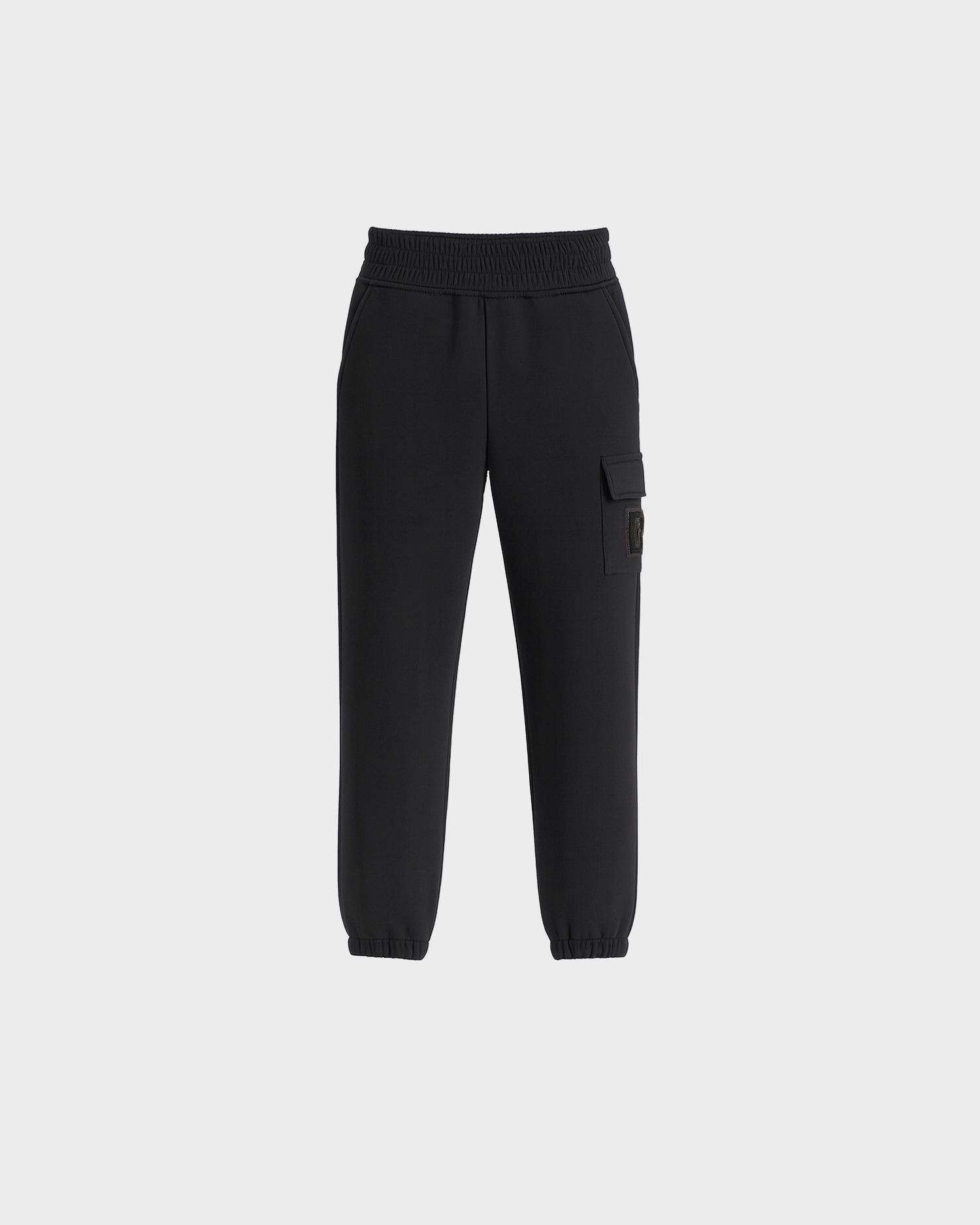 The Rudsak NOOR - 1525004 Black cargo jogger pants feature an elastic waistband, ankle cuffs, side pockets, and a buttoned flap pocket on one leg, shown against a plain white background.