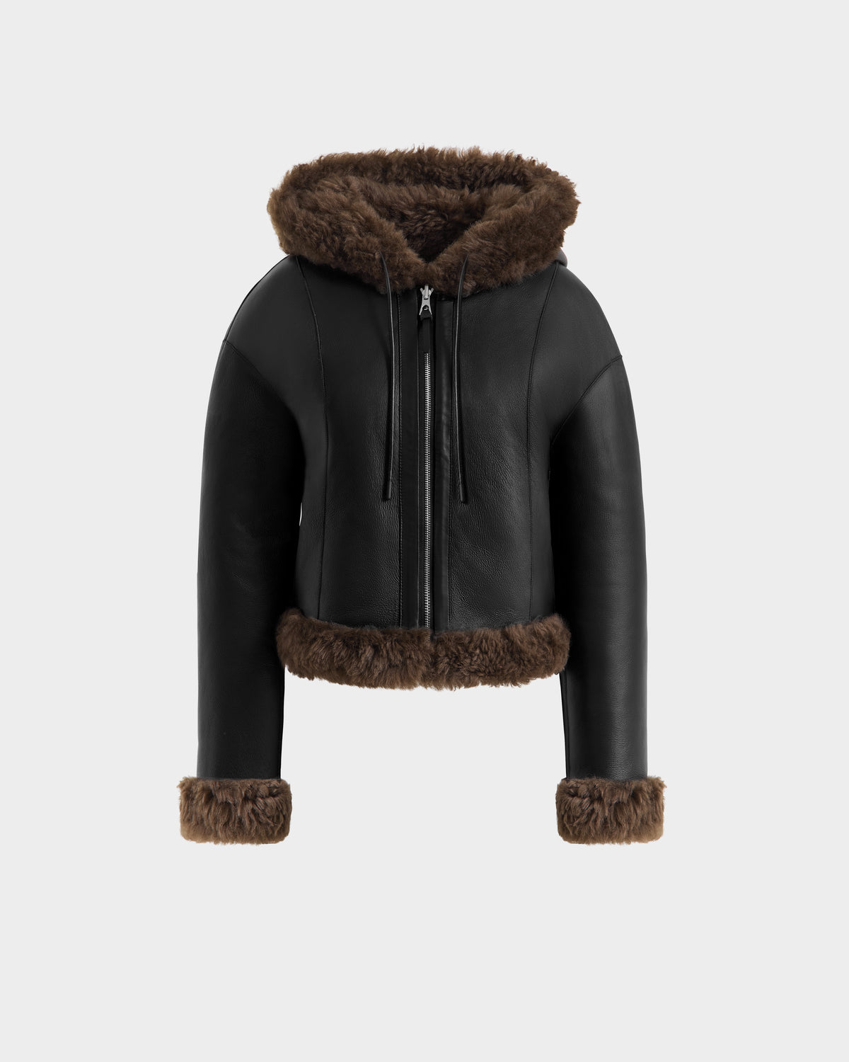 The Rudsak NORAH - 8125506 Black/Espresso womens reversible cropped jacket features black leather and espresso faux fur trim on the hood, cuffs, and hem, with a front zipper. Displayed on a light gray background.