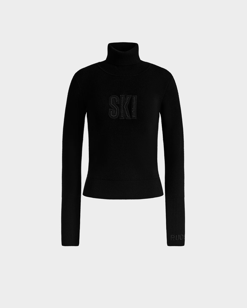 The Rudsak NOVIE - 8525659 Black is a women’s knit turtleneck sweater with ribbed cuffs and hem, featuring “SKI” in bold letters on the chest—ideal for après-ski style.