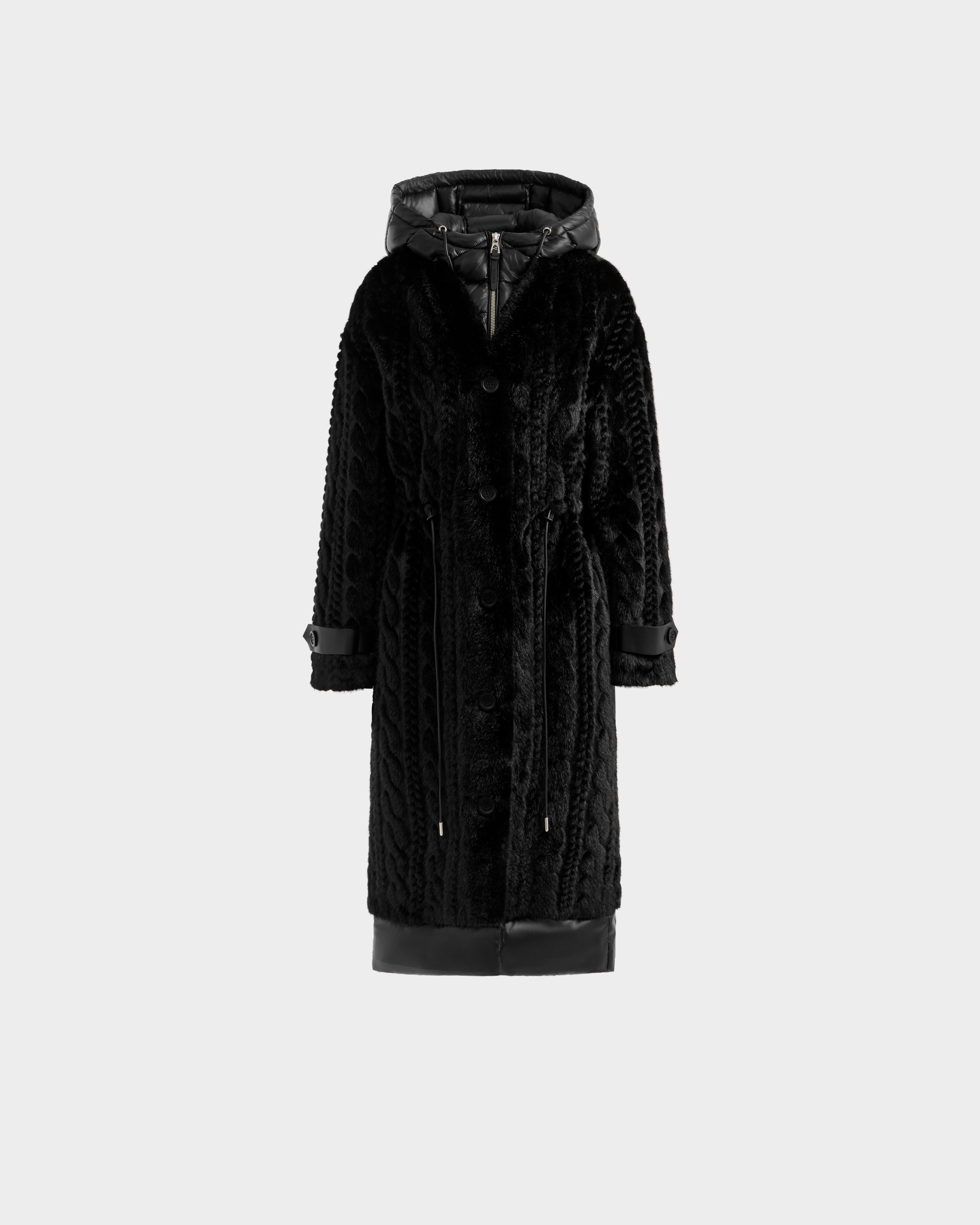 The Rudsak ORIANA - 8125545 Black women's faux fur coat features a long black design with a hood, button front, drawstring waist, and vegan leather trims on the cuffs and hem, shown on a plain light gray background.