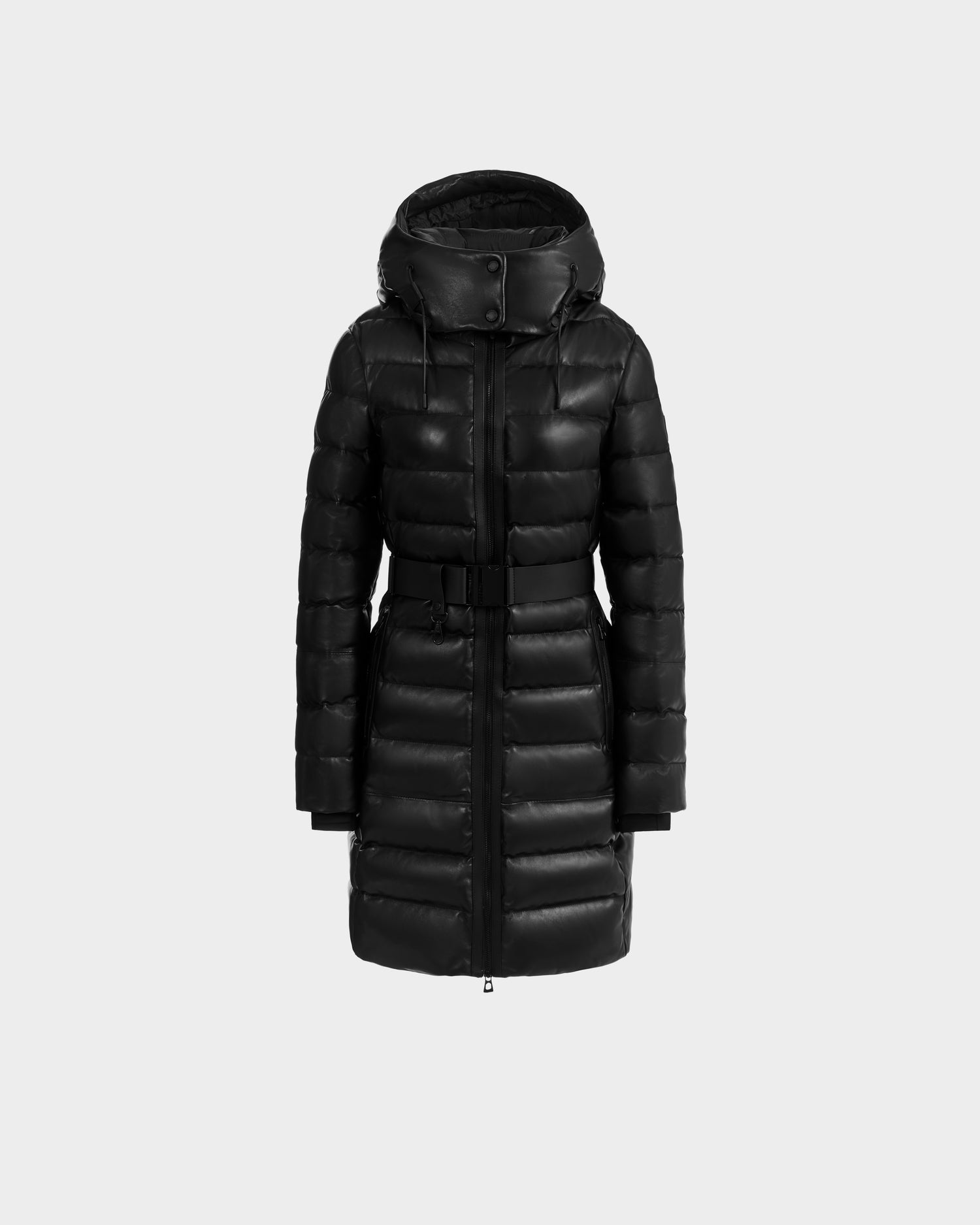 The Rudsak PELIN X - 8125575 Black is a women's long black puffer winter coat with a hood, front zipper, snap buttons, and a matching waist belt, shown on a plain light gray background.