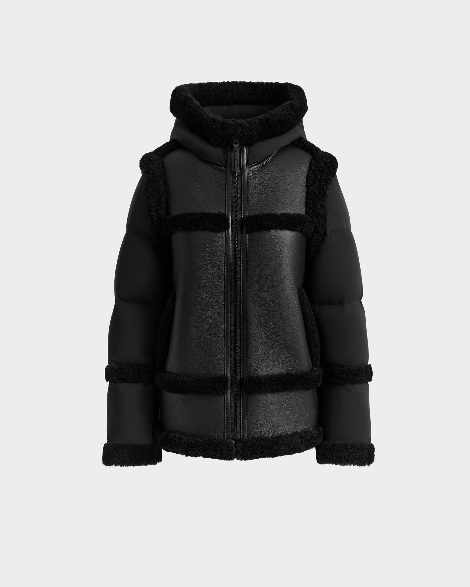 The PHEOBE - 8125510 Black shearling puffer by Rudsak features padded sleeves, a front zipper, and faux fur trim on seams, cuffs, and edges—stylish transitional outerwear for winter, shown against a plain light background.