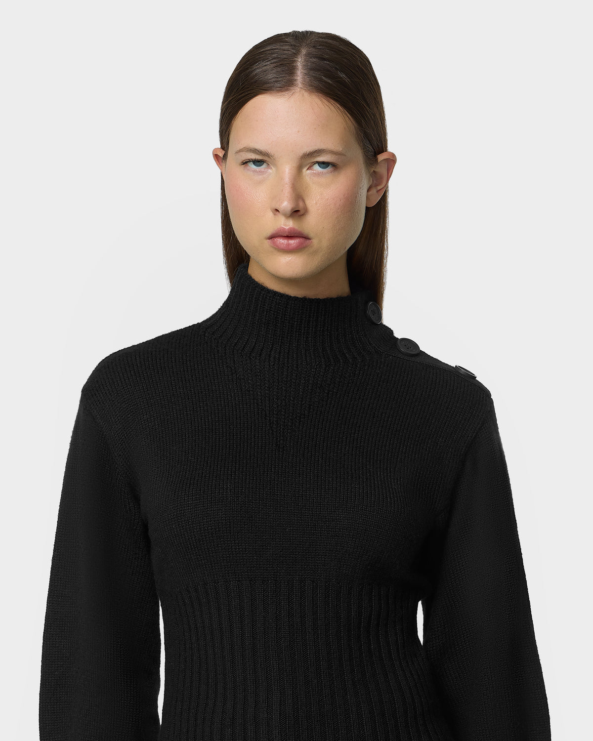 A person wearing the TATIANA - 8526694 Black ribbed mock-neck sweater with button details on the left shoulder.