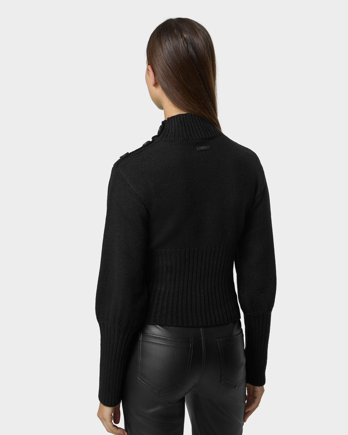 Back view of a person wearing a black TATIANA - 8526694 Black mock-neck knit sweater with button detailing on the shoulder and black pants.