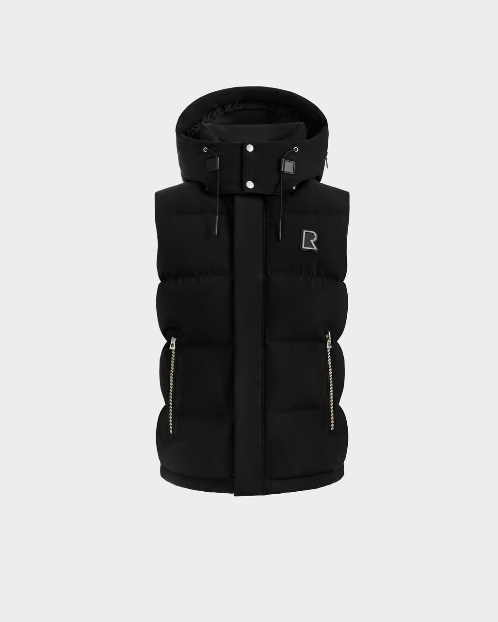 The REN H - 6125688 Black by Rudsak is a black men's puffer vest with a hood, front zipper, snap buttons, zippered side pockets, and an embroidered R logo on the chest, shown on a plain light gray background.