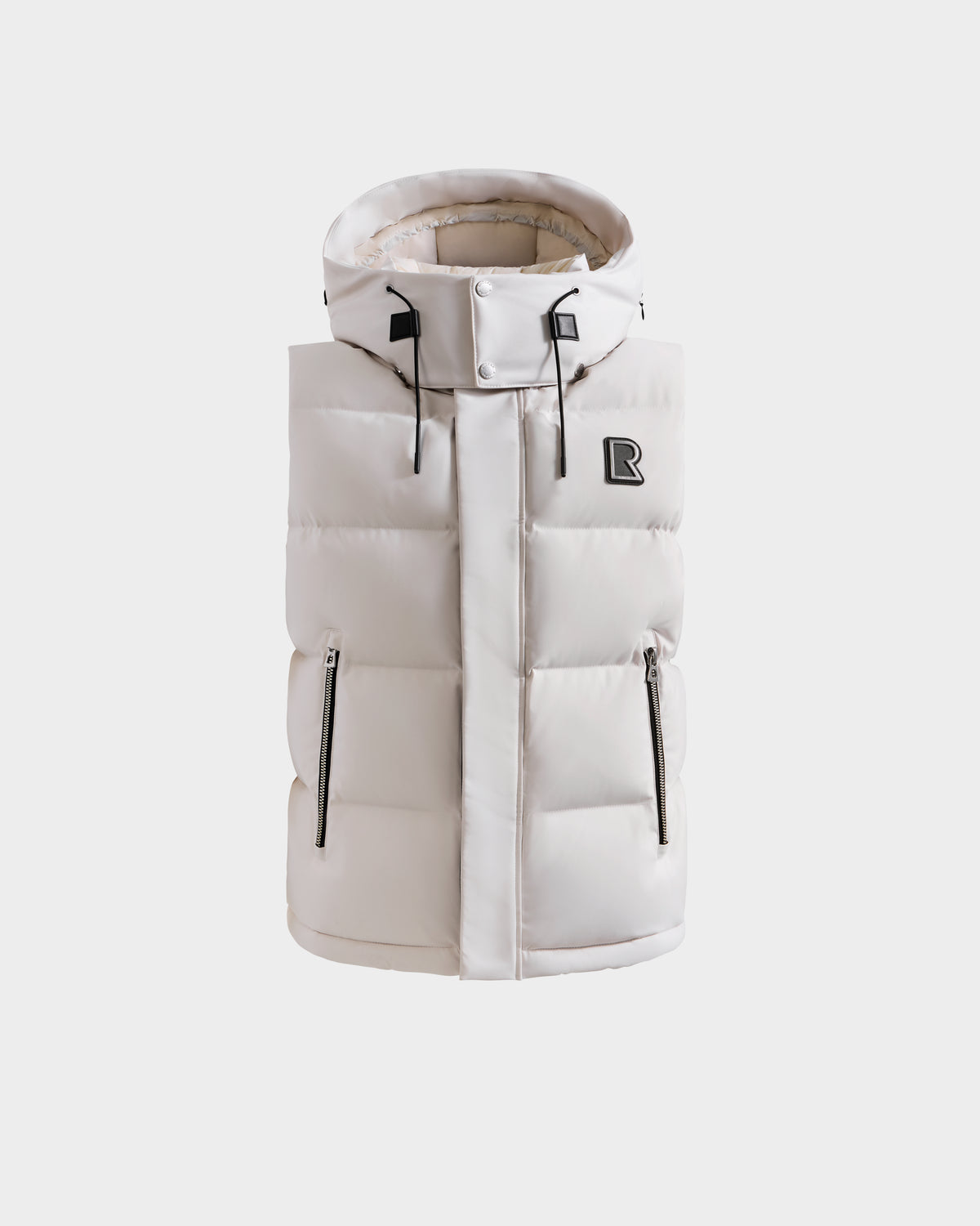 The Rudsak REN H - 6125688 Vanilla men's quilted down puffer vest in light beige features a high collar, zipper closure, two front zippered pockets, and a black R logo on the chest—ideal for layering on chilly days.