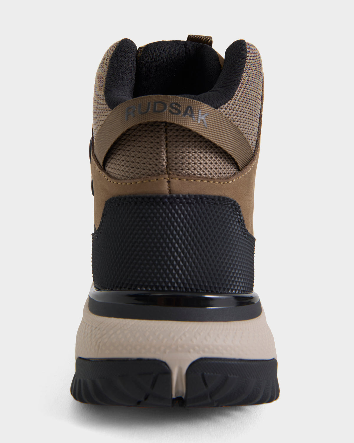 Rear view of the REXON - 6226503 Cement high-top sneaker by Rudsak, shown in brown, black, and beige with “RUDSAK” printed on the heel strap, featuring a textured sole and mesh upper material.