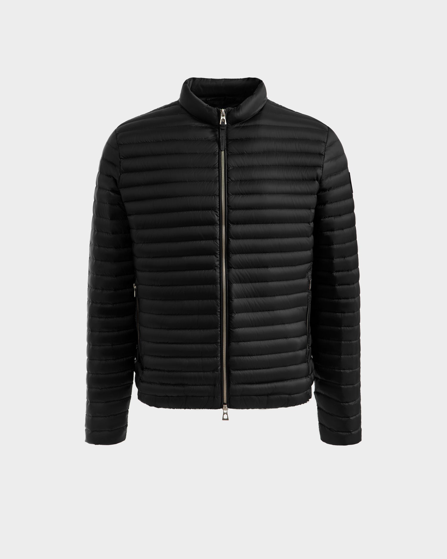 The Rudsak REYMOND M - M125523 Black men’s down jacket features RDS-certified down, quilted horizontal stitching, a zip-up front, long sleeves, and a short collar, shown against a plain light gray background.