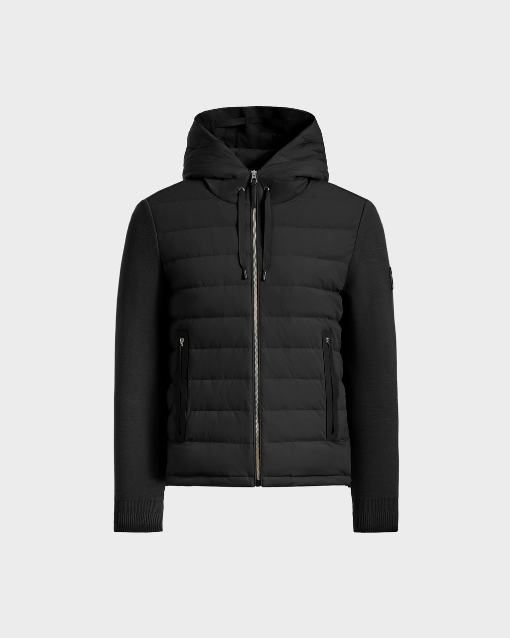 The Rudsak RIVER HV - H125503 Black is a limited edition hybrid hooded down jacket with quilted panels, knitted sleeves, and two zippered side pockets, shown on a plain light gray background.