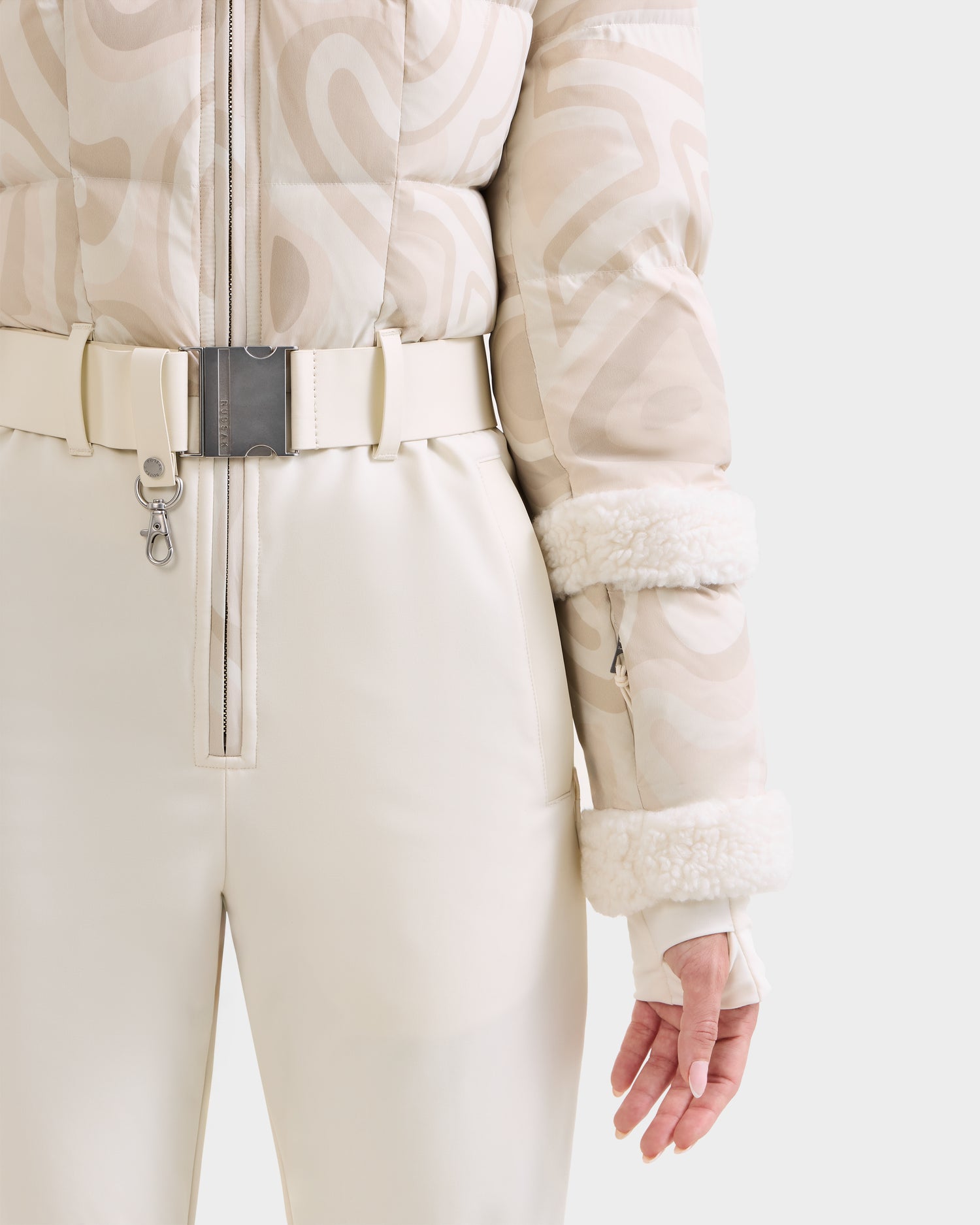 A person wearing Rudsak's CARMEN P - 8125707 Vanilla Deja vu pants and beige puffer jacket with furry cuffs, shown from the chest down. Now available for pre-order; ships by November 30th.