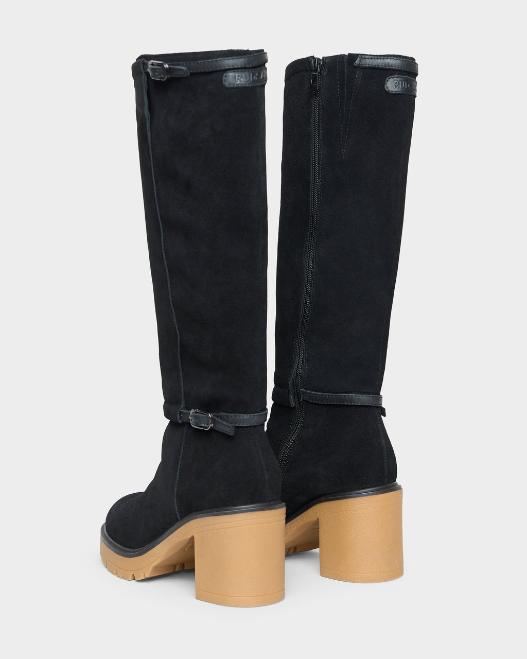 Back view of STEPRA - 8226524 Black knee-high boots with side zippers, thin ankle straps, and thick tan block heels with lugged soles.