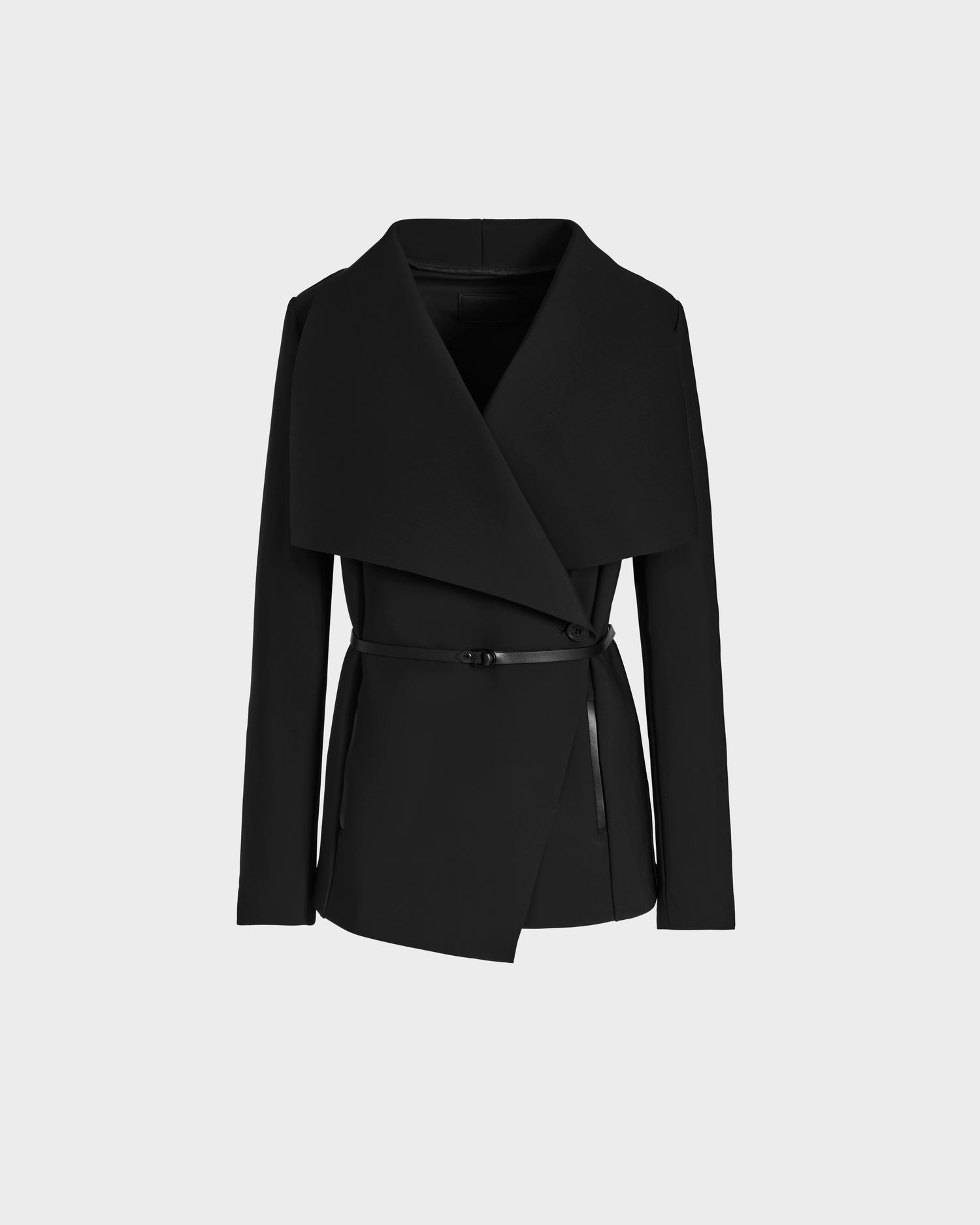 The SABRINA - L125016 Black by Rudsak is a black women's wrap coat with long sleeves, an oversized collar, and asymmetrical front, cinched with a slim vegan leather belt. Displayed on a plain white background.