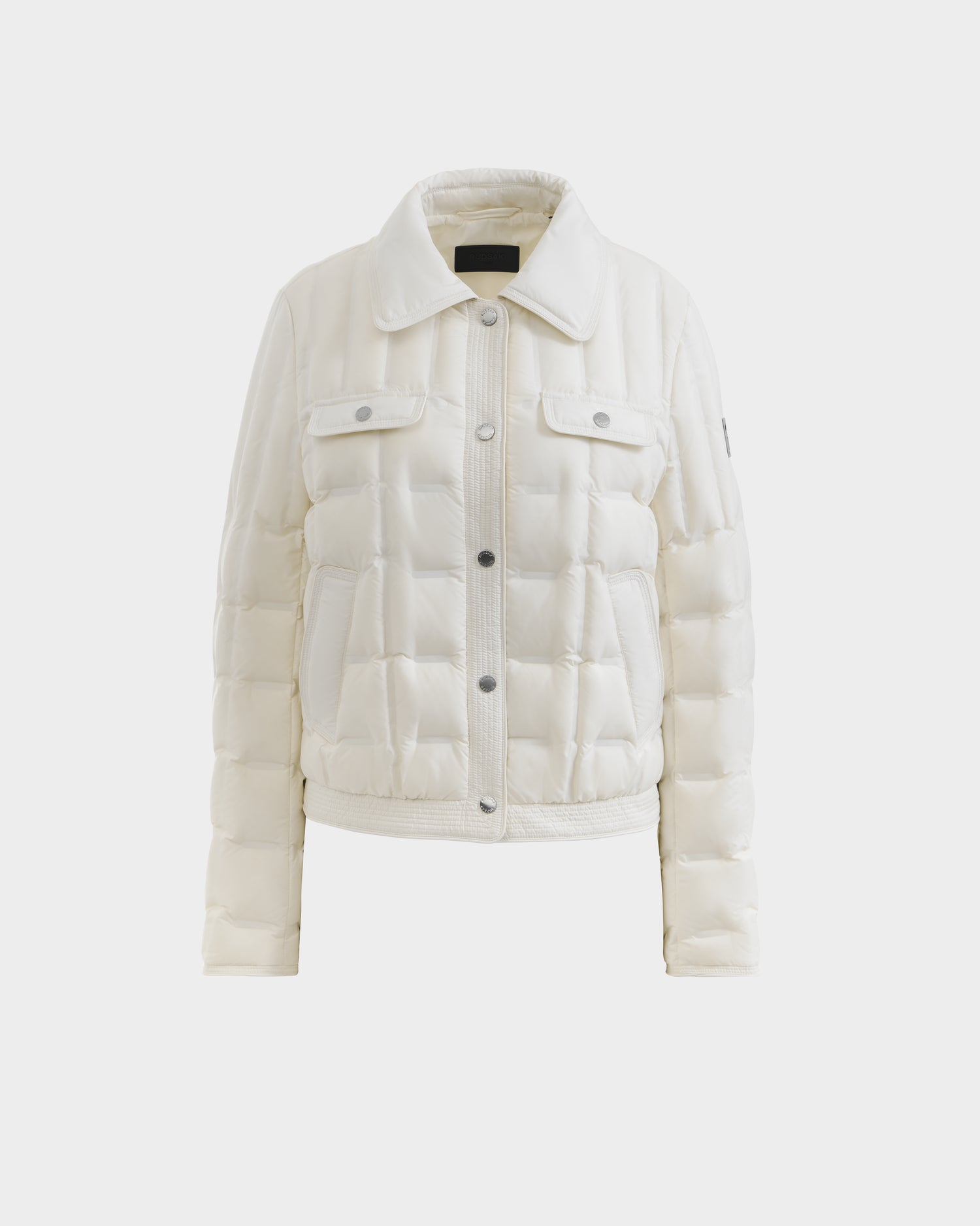 The Rudsak SEOUL - 8126027 Iceland is a white collared down-fill quilted shirt jacket with button-down front, flap chest pockets, and long sleeves, providing lightweight warmth. Shown on a plain white background.