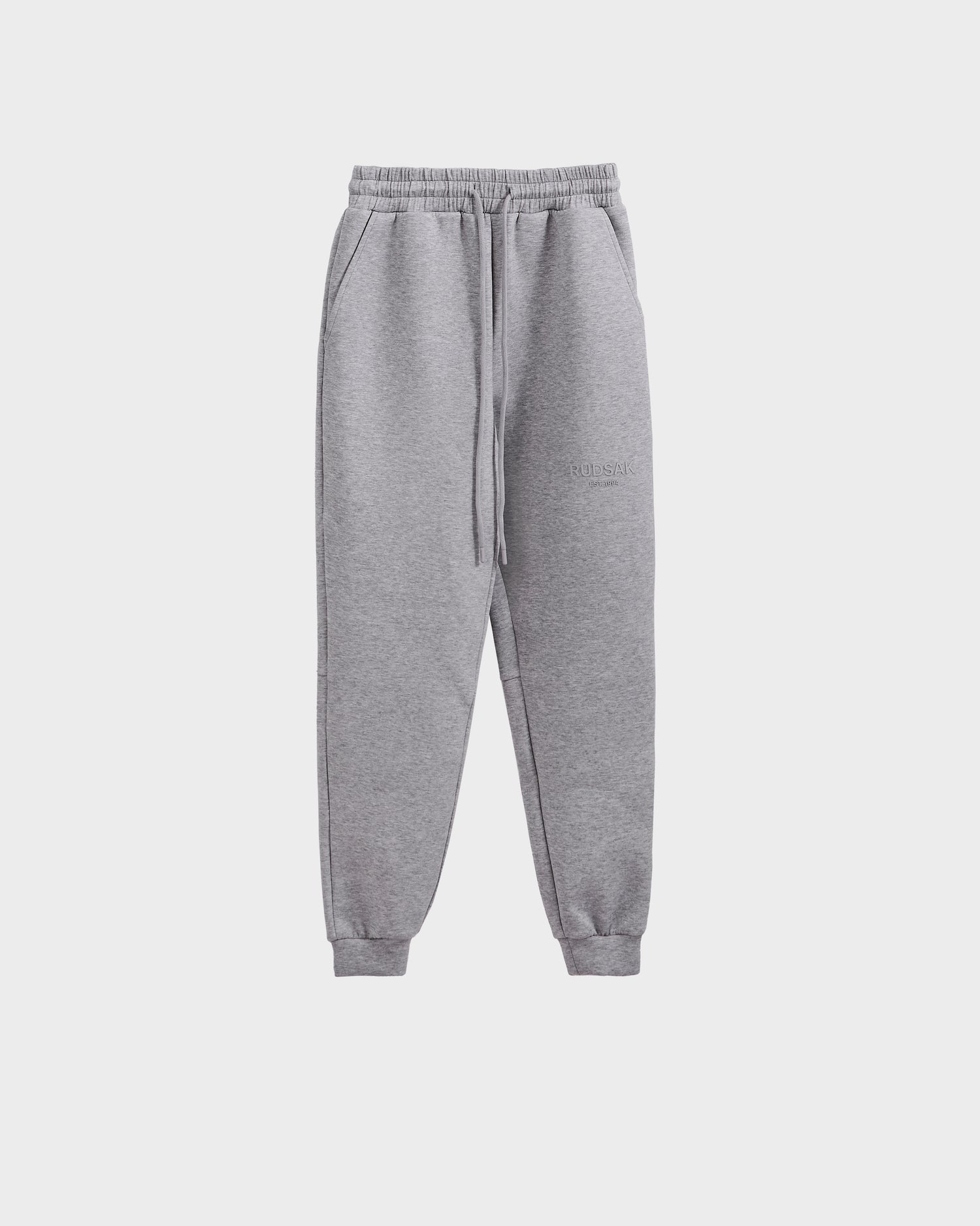 The Rudsak JOSS - 9524009 joggers in heather grey (M) feature premium cotton, an elastic waistband with drawstring, side pockets, and cuffed ankles, shown on a plain white background.