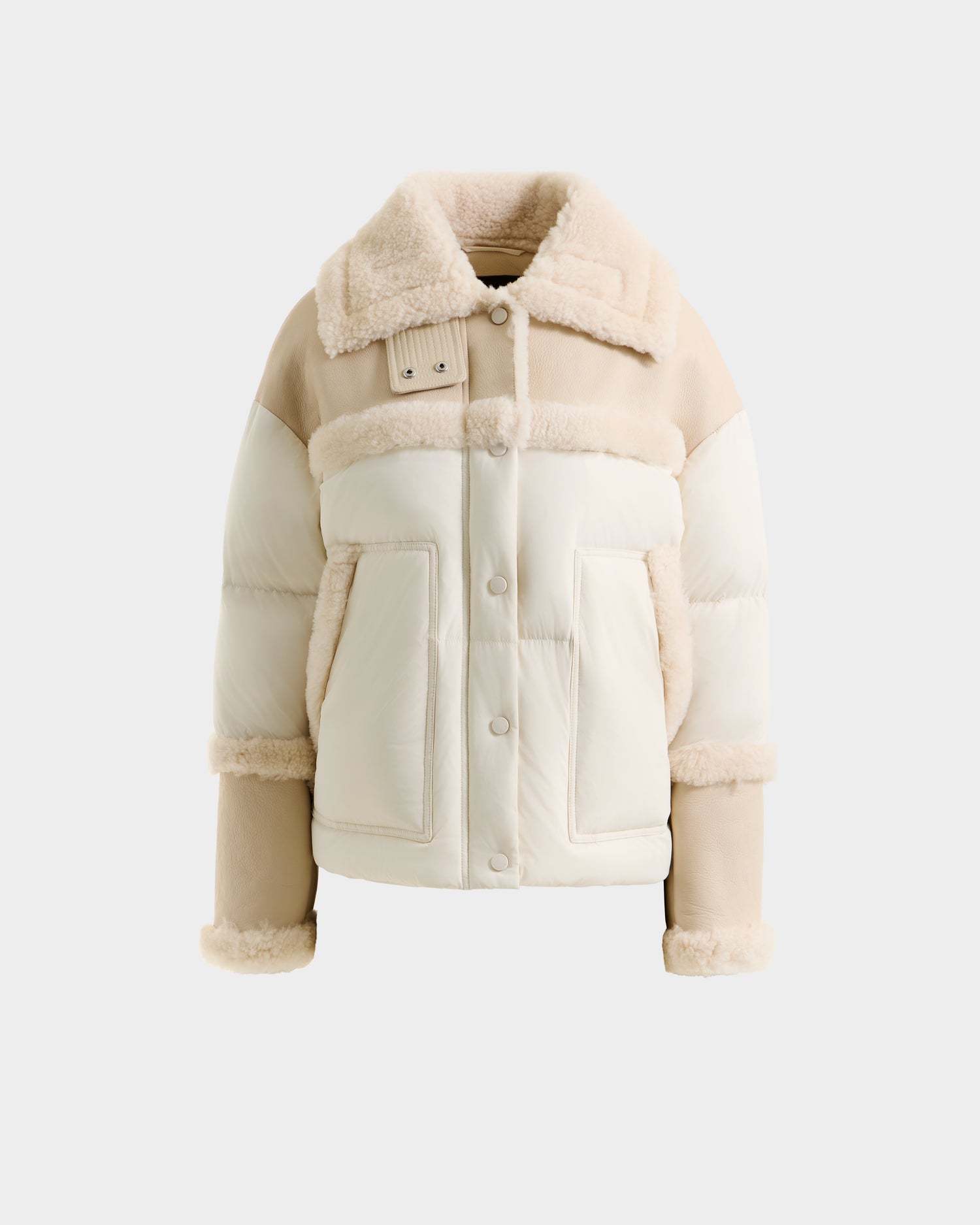 The SHIRLEY - 8125613 Vanilla shearling jacket by Rudsak, in beige and cream with faux shearling trim, large front pockets, and button closure, is displayed against a plain white background.