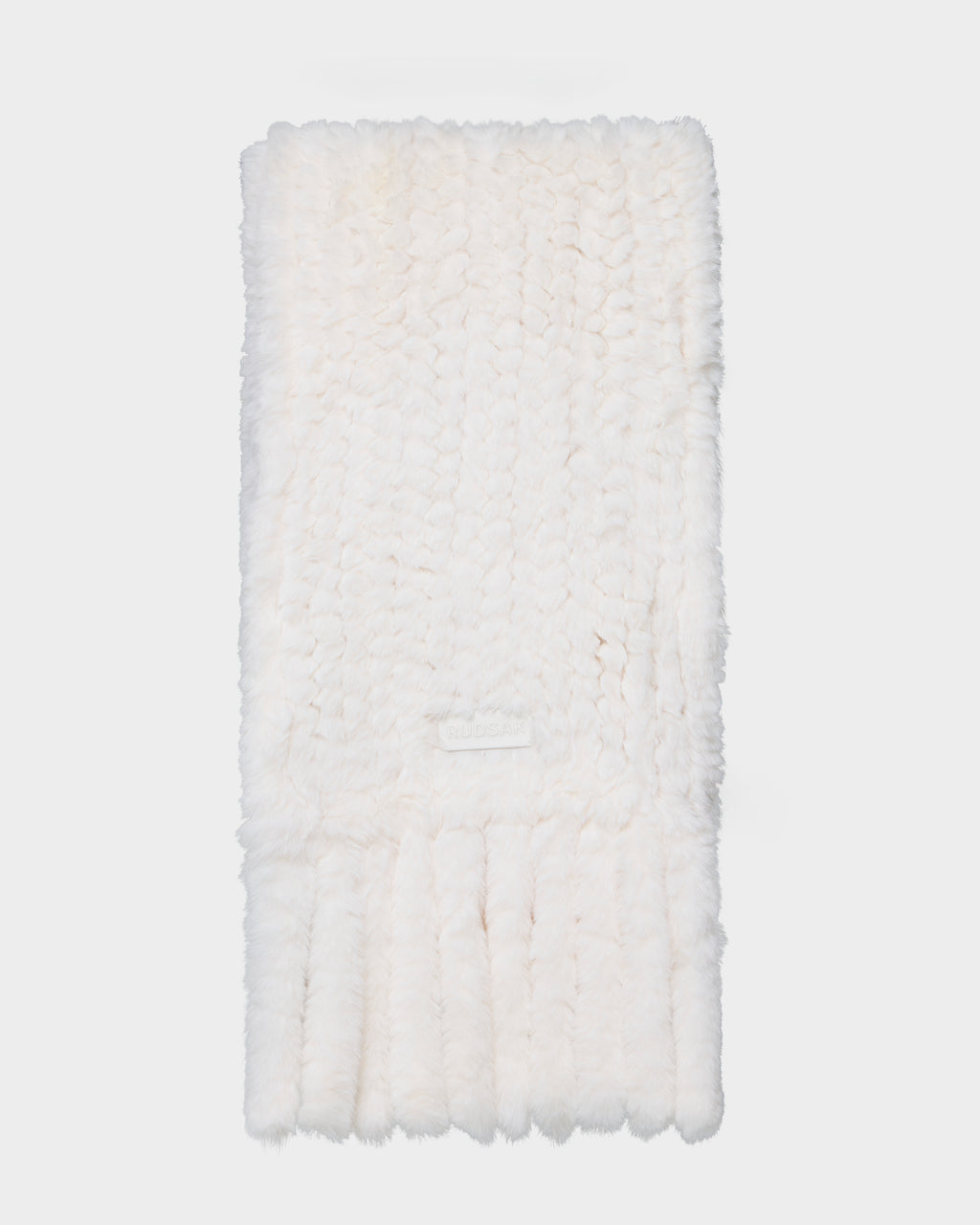 The Rudsak TAVIA - 8426511 Vanilla is a soft, white, knitted scarf with a fluffy texture and ribbed ends, shown neatly folded on a plain white background.