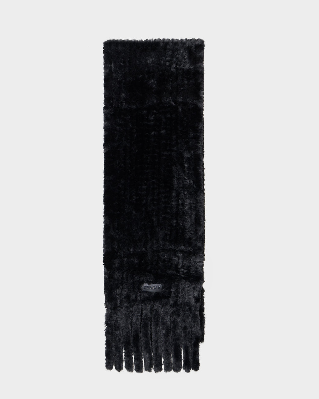 The TAVIA - 8426511 Black scarf by Rudsak features soft, plush black faux fur with a short fringe on one end, shown against a light gray background.