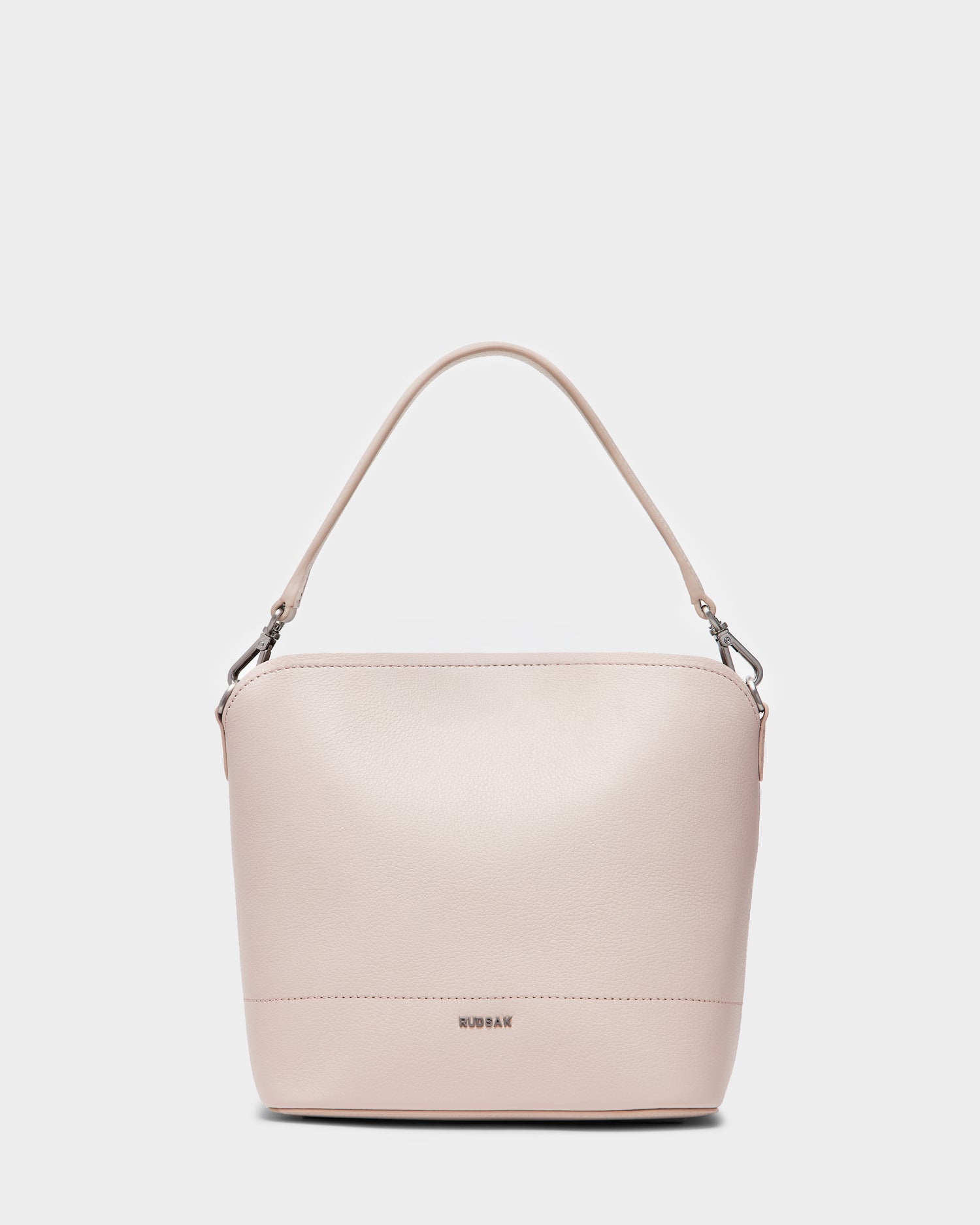 The Rudsak ANIA SM - 8325009 Soft Pink is a compact women’s pebble leather hobo bag with a single rounded handle and subtle silver hardware, featuring the brand name embossed in gold near the base against a white background.