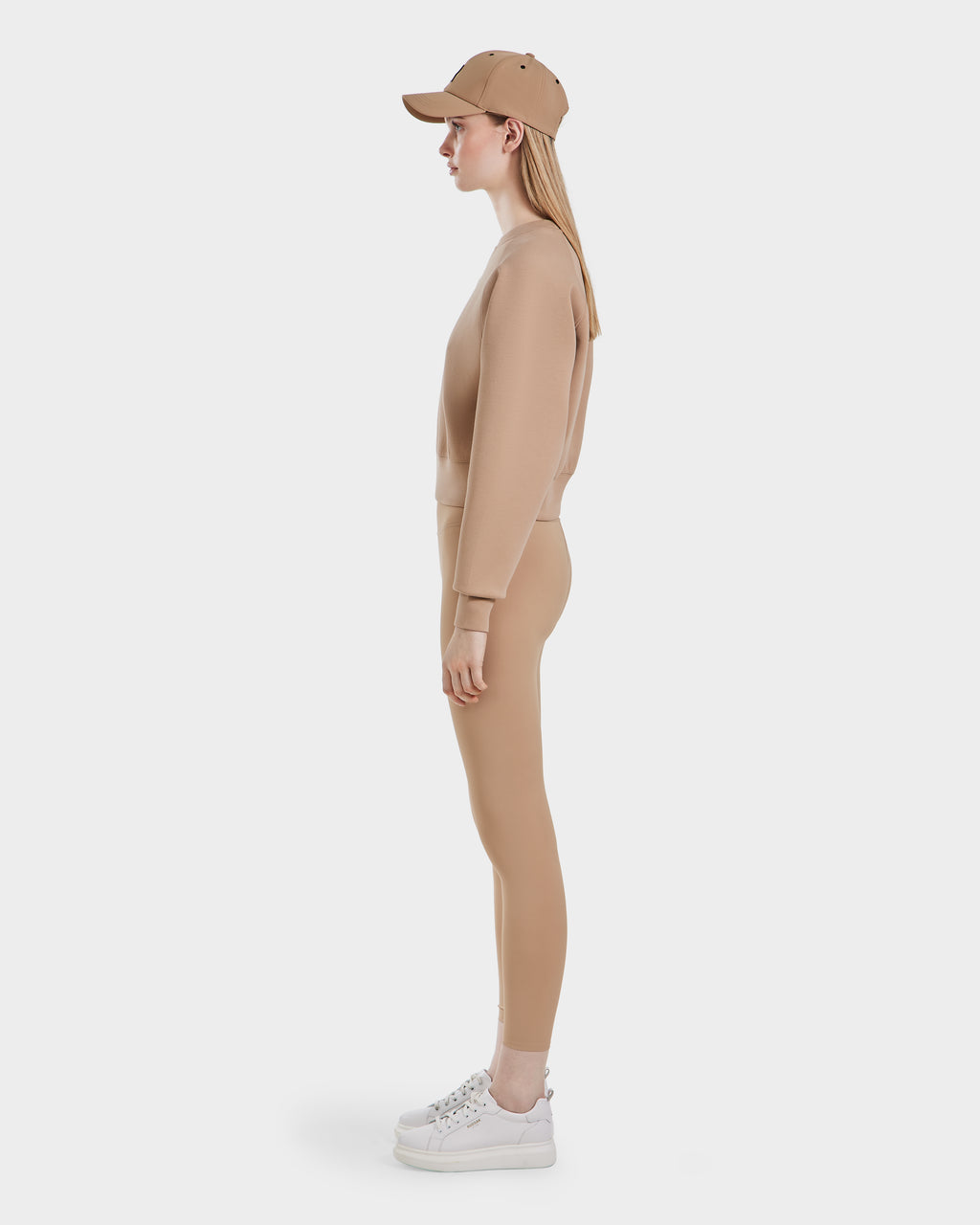 A woman wearing the Rudsak BETSY - 8525087 Almond premium cotton blend crewneck sweater.