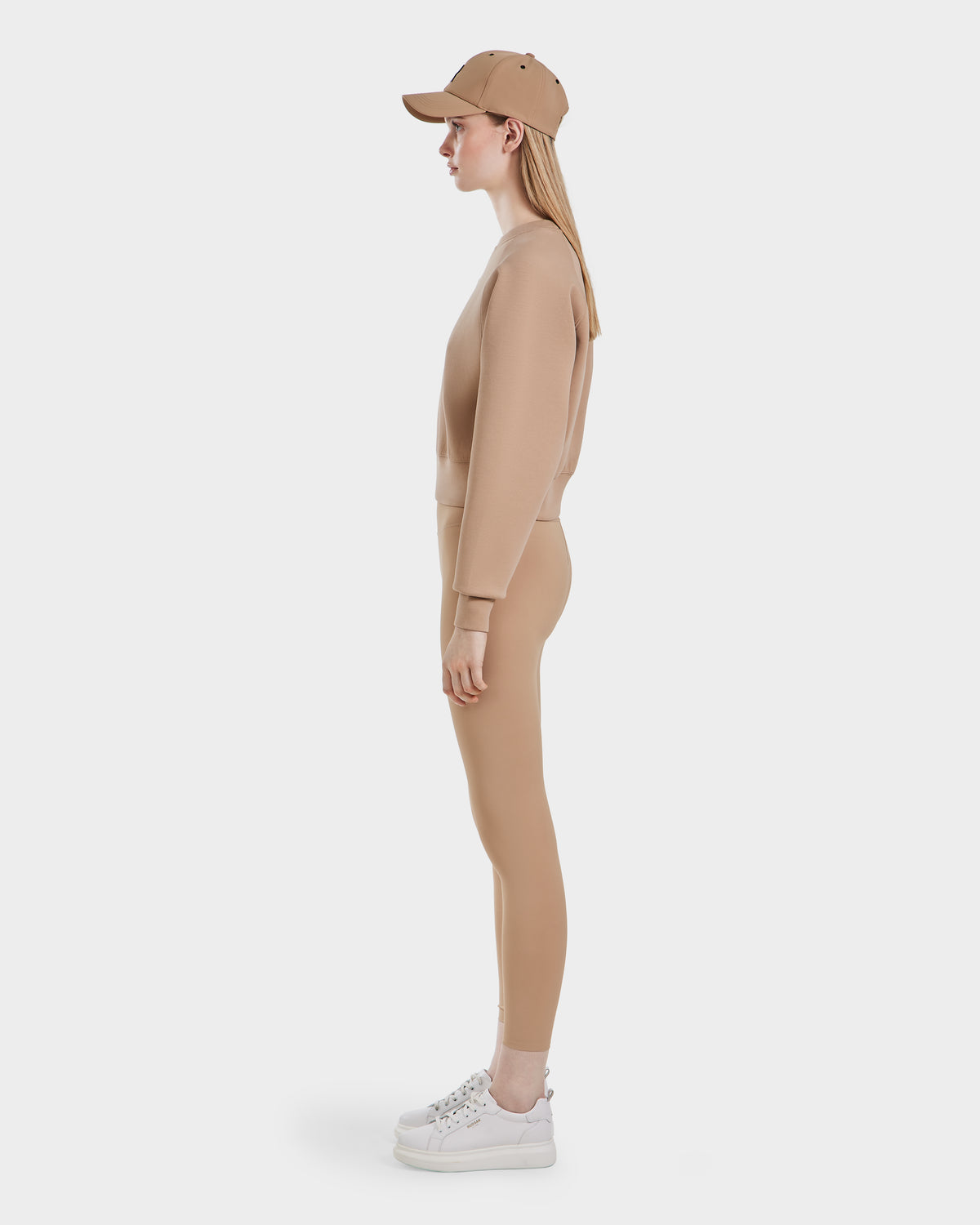 A woman wearing the Rudsak BETSY - 8525087 Almond premium cotton blend crewneck sweater.