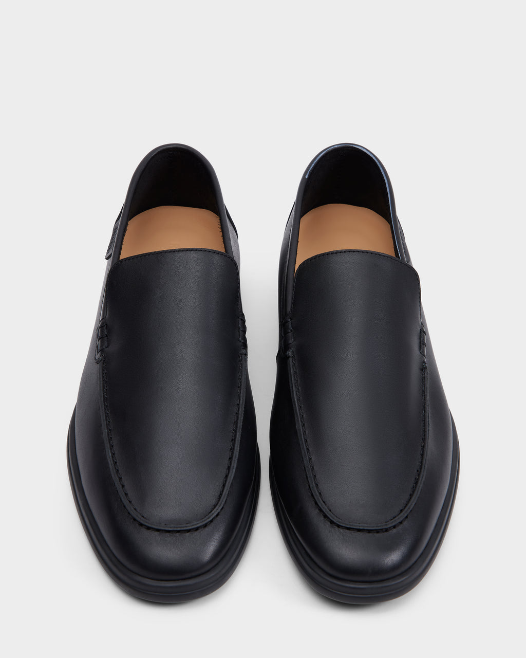 The Rudsak CHANNING - 6225005 Black men’s leather loafers, shown from above on a light gray background, feature premium smooth black leather, slip-on design, rounded toes, and minimal stitching for a timeless look.