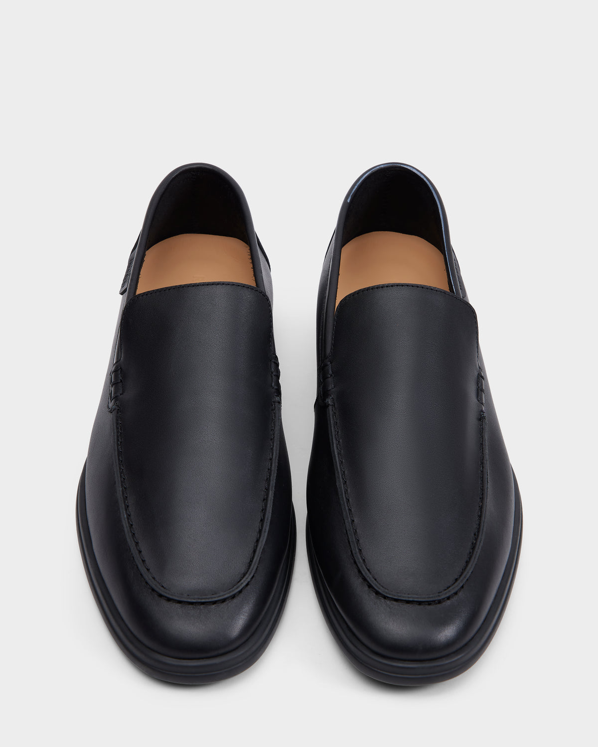 The Rudsak CHANNING - 6225005 Black men’s leather loafers, shown from above on a light gray background, feature premium smooth black leather, slip-on design, rounded toes, and minimal stitching for a timeless look.