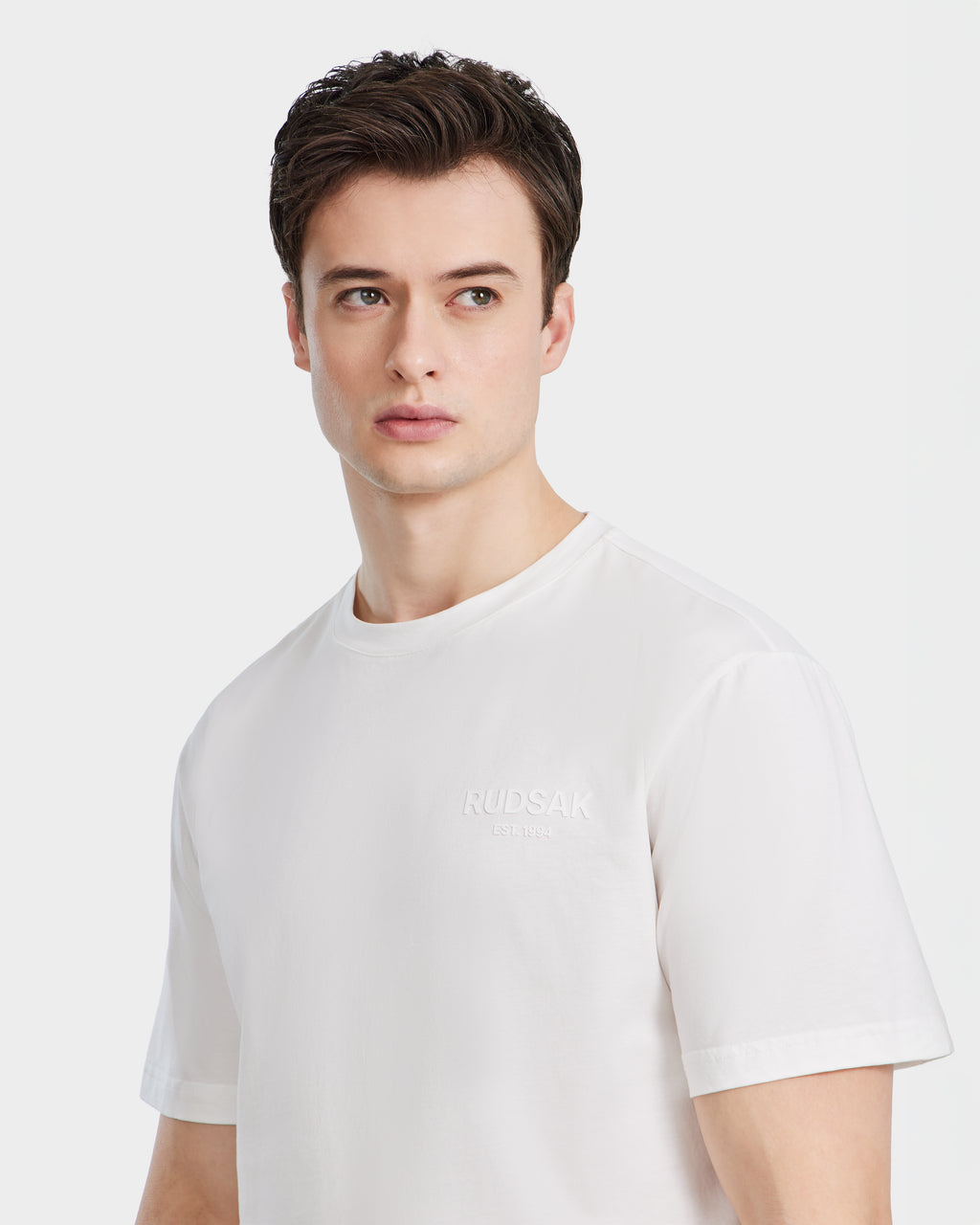A young man with short brown hair wears the GRANT - 6525036 Iceland mens tee by Rudsak, made from premium cotton, as he looks slightly to his left against a light background.