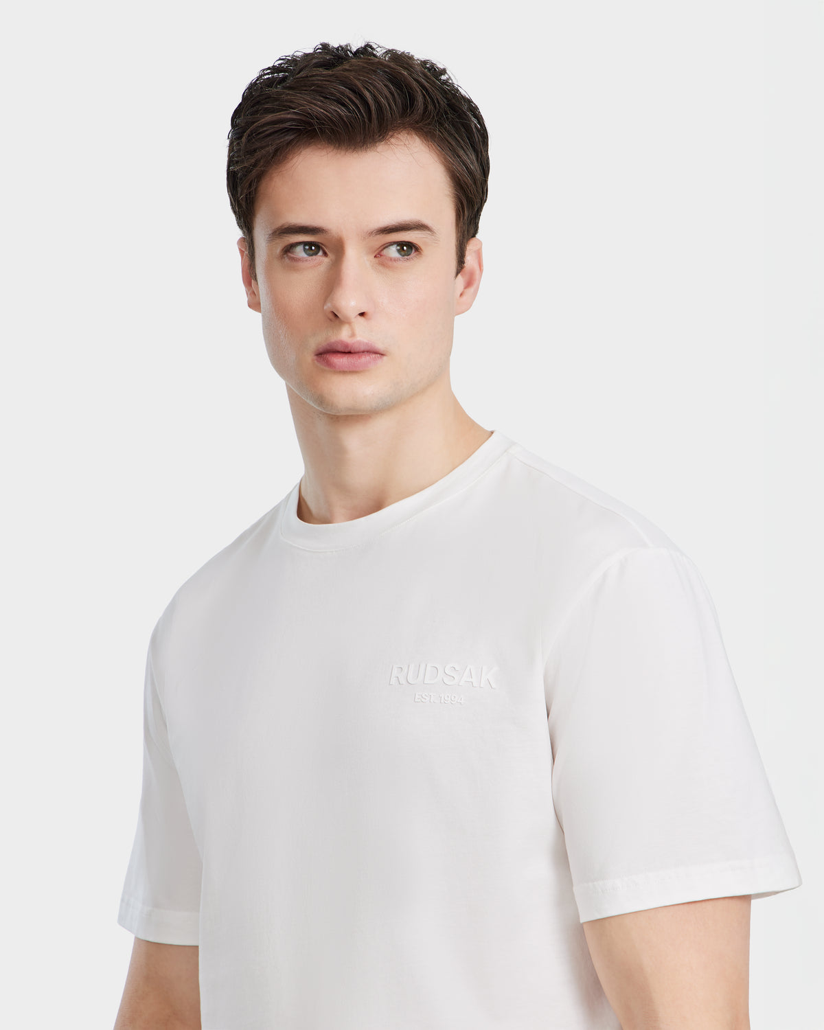 A young man with short brown hair wears the GRANT - 6525036 Iceland mens tee by Rudsak, made from premium cotton, as he looks slightly to his left against a light background.