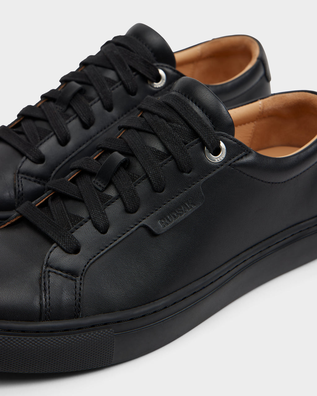 The Rudsak LARIS - 6225000 Black is a pair of men’s black leather sneakers in a classic lace-up style.