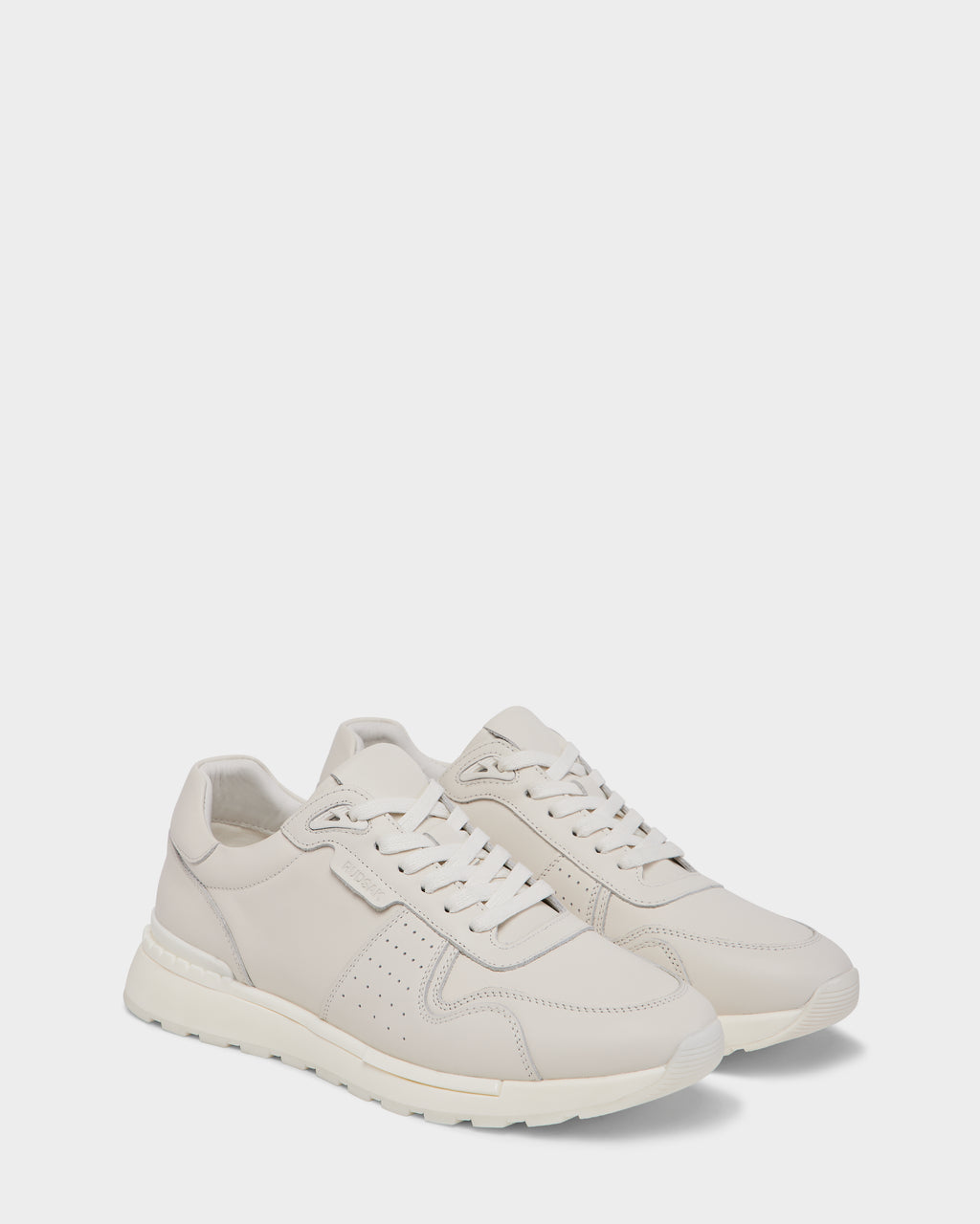 The Rudsak MALONE - 6225010 Iceland offers off-white men’s leather sneakers with white soles, laces, and subtle stitching—expertly crafted for everyday wear—shown side by side on a simple light background.