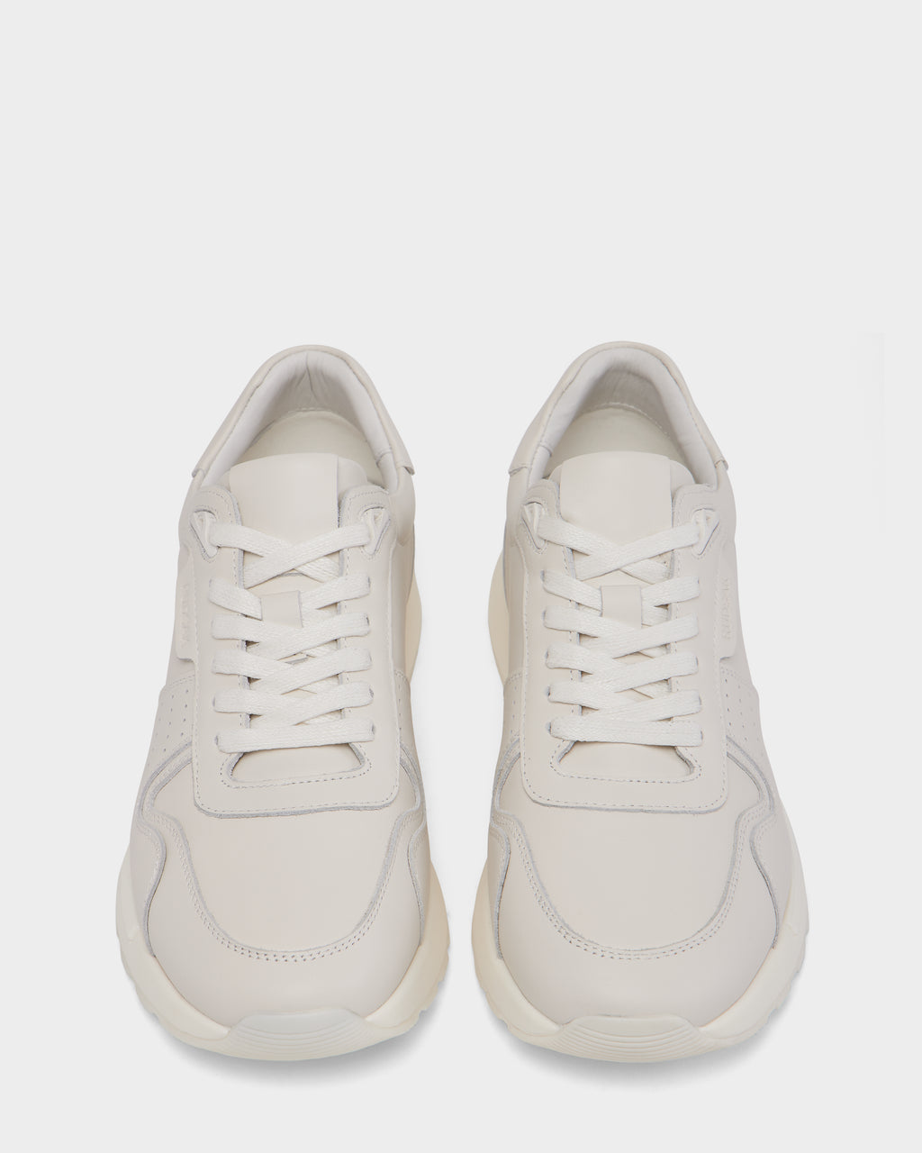 The Rudsak MALONE - 6225010 Iceland men’s sneakers feature a minimal, modern design in smooth white leather with white laces and subtle stitching—premium everyday footwear shown from above on a plain white background.