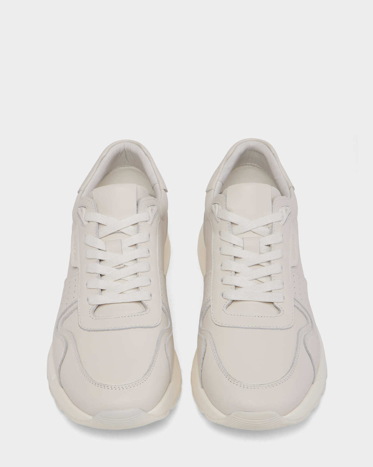 The Rudsak MALONE - 6225010 Iceland men’s sneakers feature a minimal, modern design in smooth white leather with white laces and subtle stitching—premium everyday footwear shown from above on a plain white background.