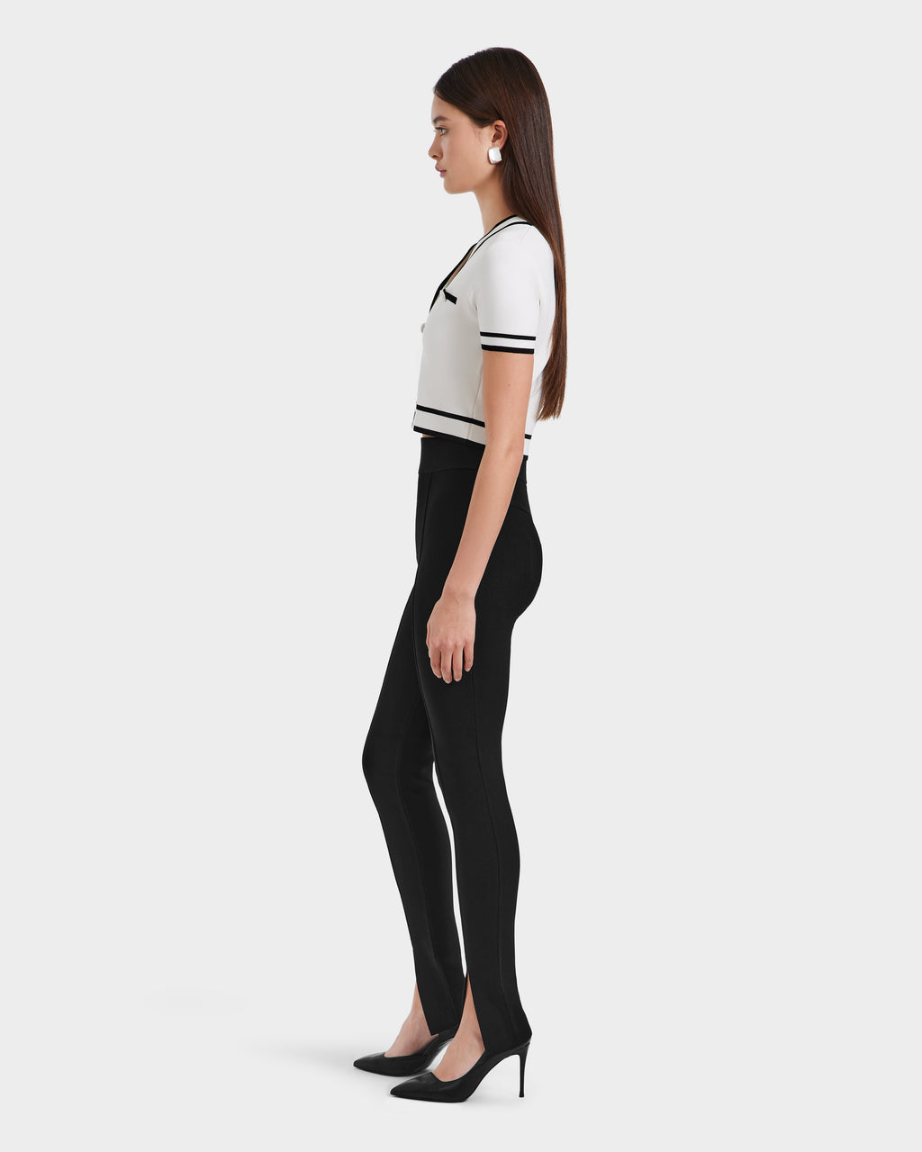A woman in a white shirt and black MATHILDA - 8524515 leggings by Rudsak.