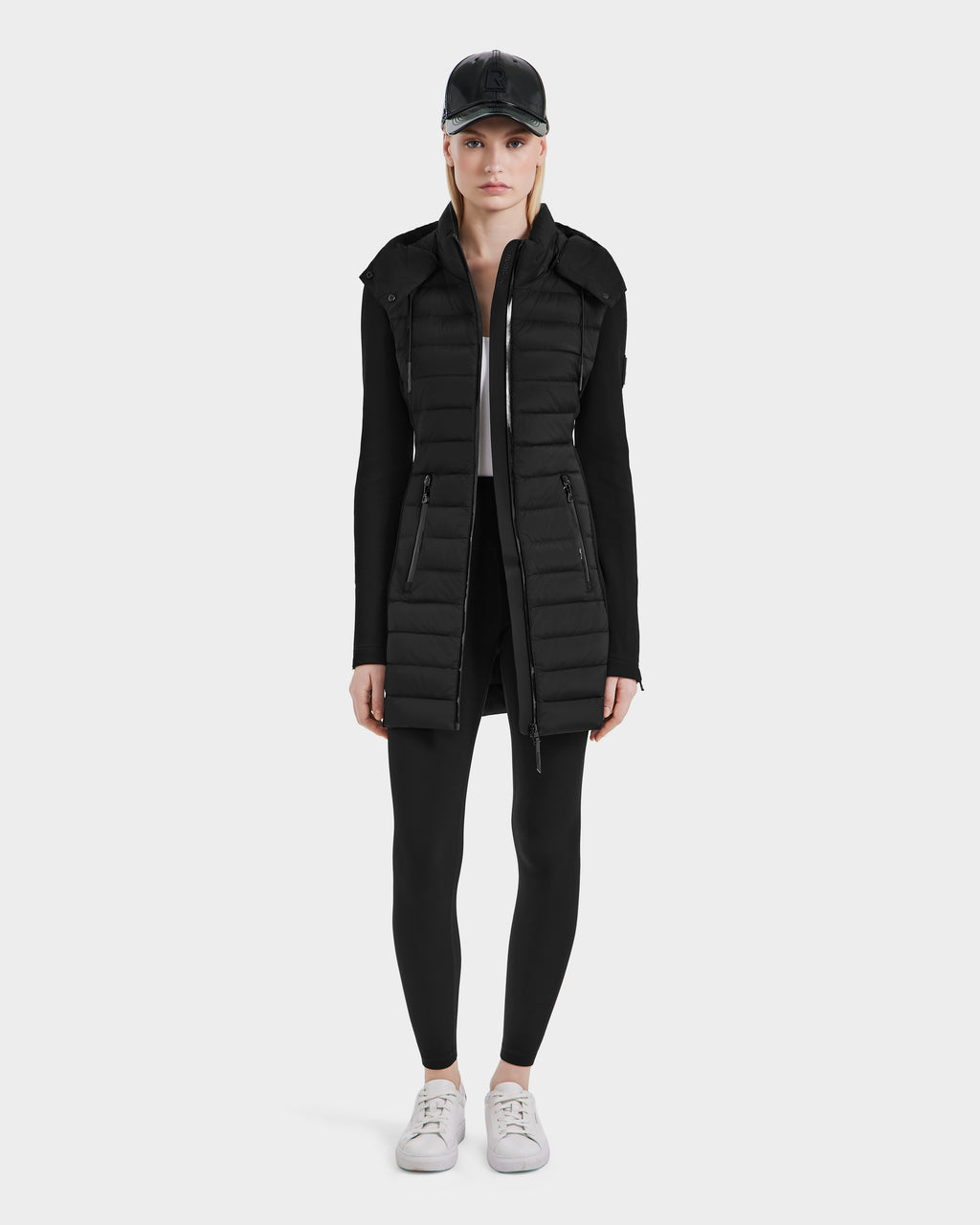 A woman stands confidently in the Rudsak MERINA - 8124826 Black women’s light jacket, highlighting its versatility and comfort.