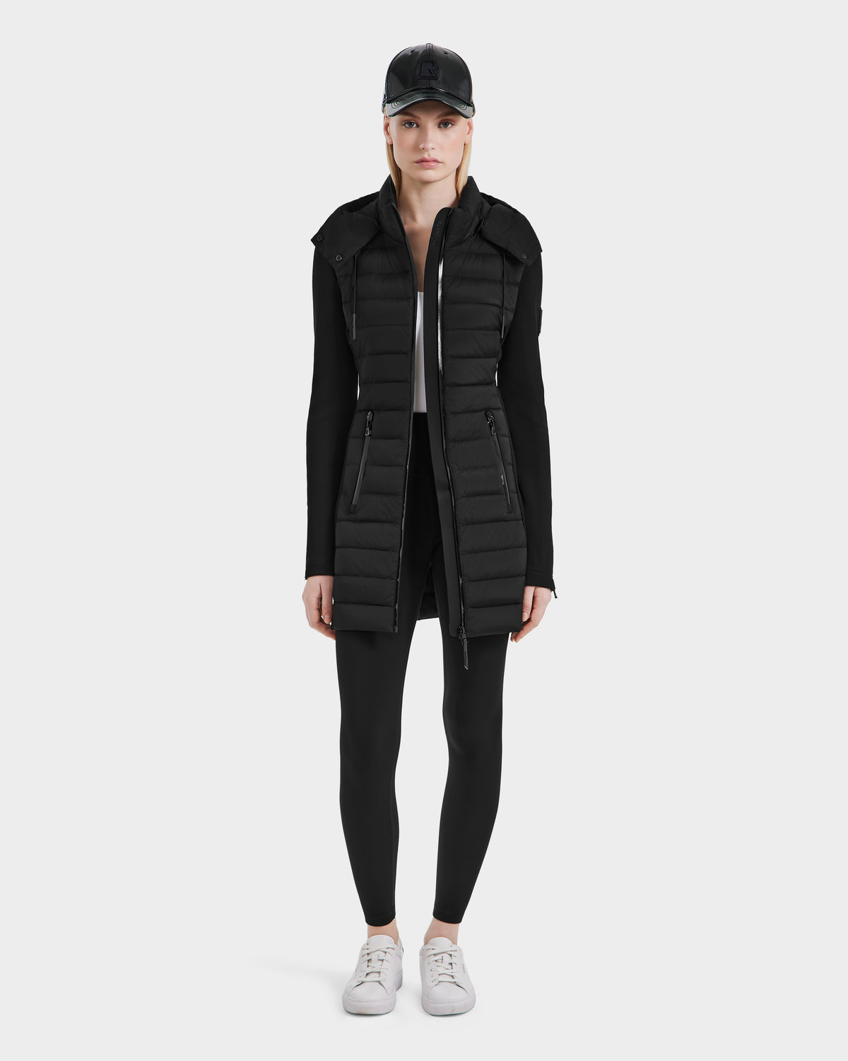A woman stands confidently in the Rudsak MERINA - 8124826 Black women’s light jacket, highlighting its versatility and comfort.