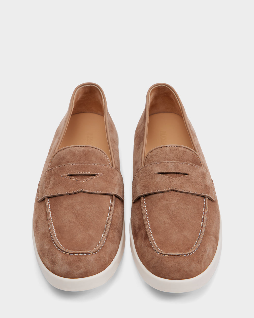 The RABECCA - 8225006 Almond womens luxury loafers by Rudsak feature light brown suede, white stitching, and white rubber soles, shown from above on a plain white background.