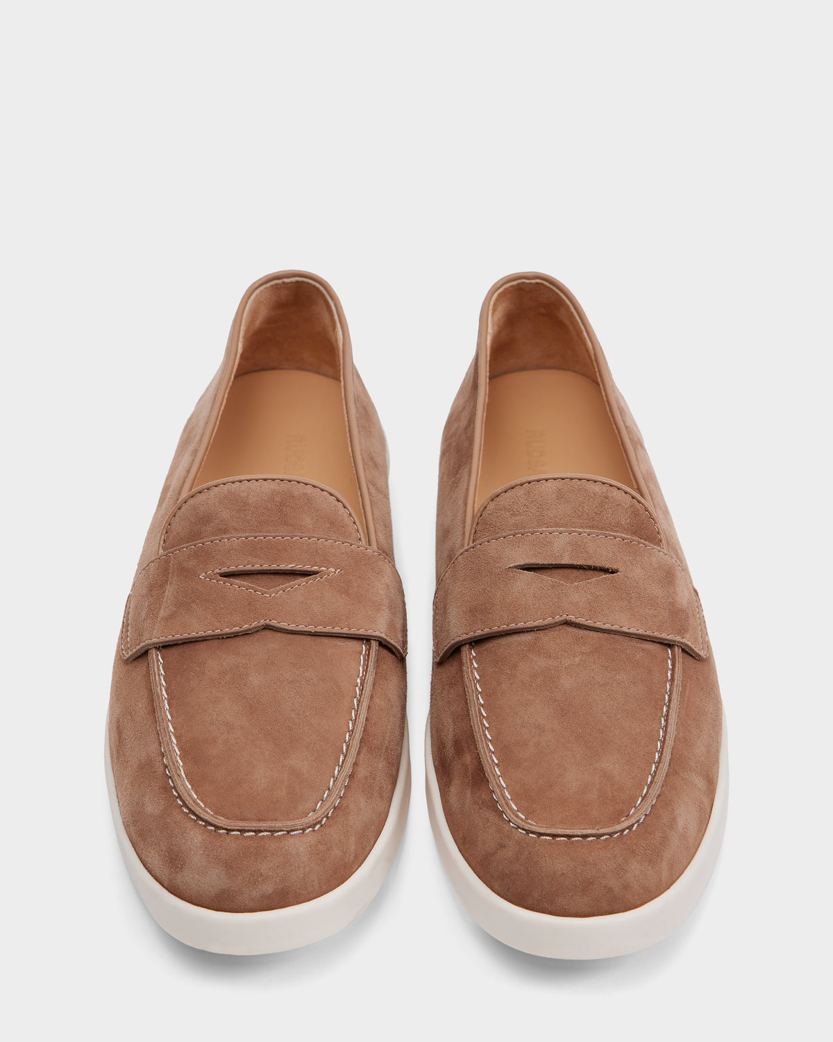 The RABECCA - 8225006 Almond womens luxury loafers by Rudsak feature light brown suede, white stitching, and white rubber soles, shown from above on a plain white background.