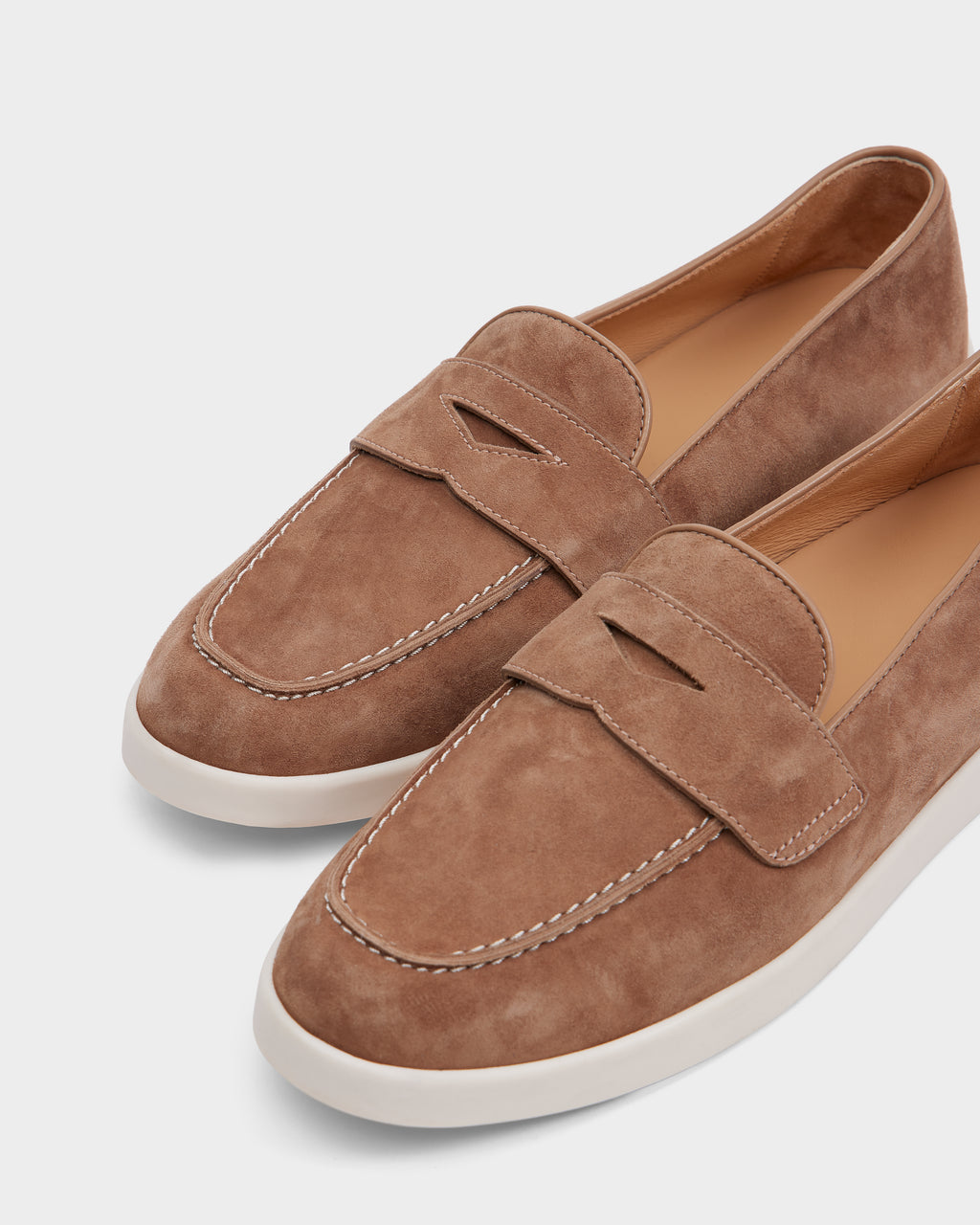 The RABECCA - 8225006 Almond by Rudsak are womens luxury brown suede loafers with white stitching and rubber soles, elegantly displayed on a light background.
