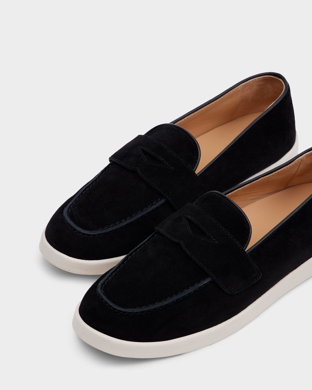 The RABECCA - 8225006 Black by Rudsak are womens luxury black suede loafers with white rubber soles and a tan leather interior, displayed on a plain light gray background.