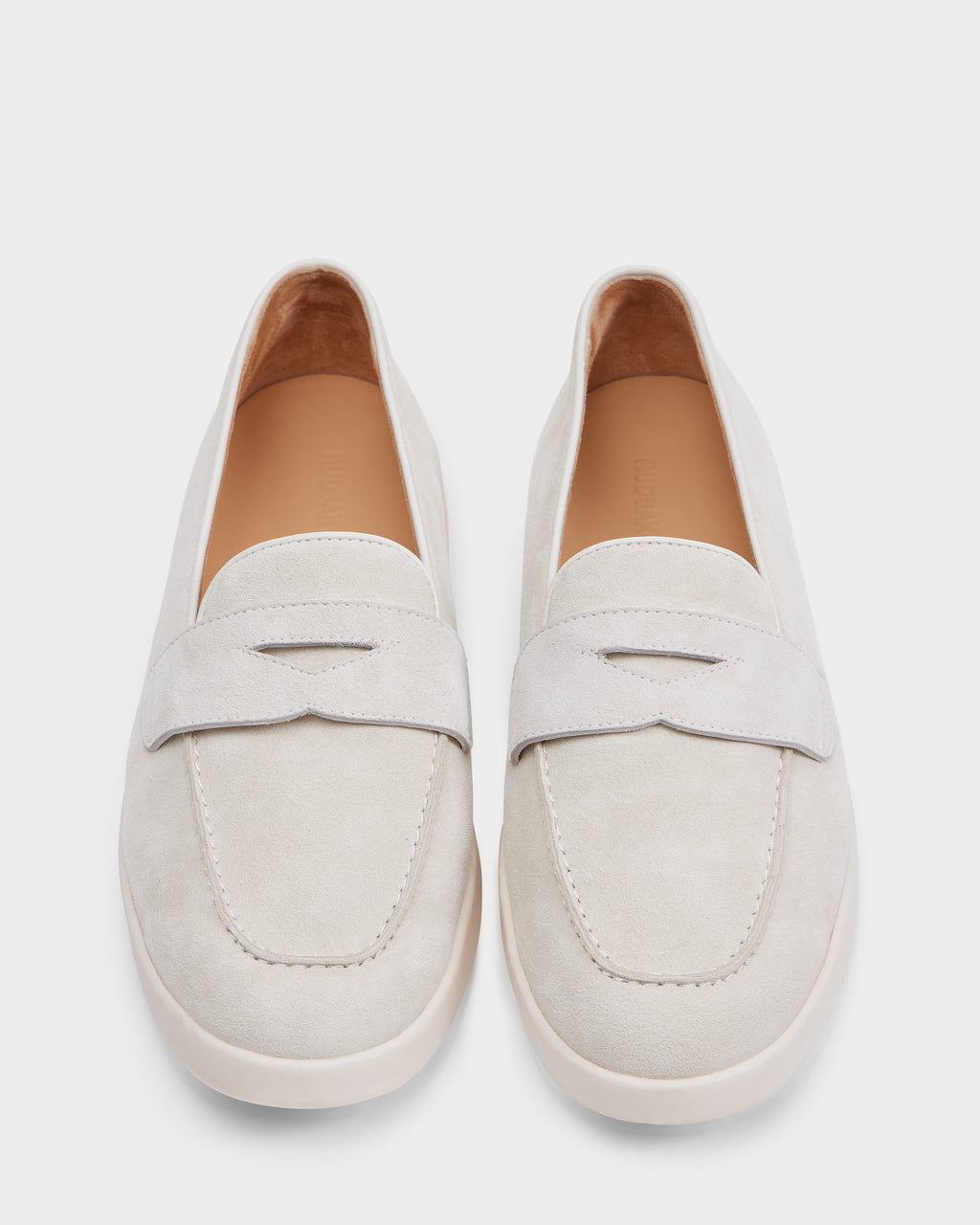 The RABECCA - 8225006 Iceland by Rudsak features light beige suede loafers with rounded toes and a matching band, shown from above on a white background—an elegant choice for any women’s luxury footwear collection.