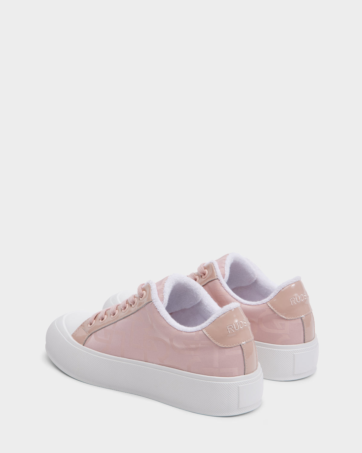 A pair of Rudsak RIMA - 8225001 Blush Pattern vegan leather sneakers in light pink with white laces, white soles, and RUDSAK on the back heel, displayed against a plain white background.