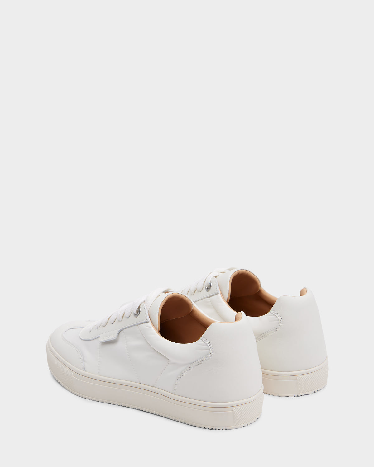 The Rudsak SKYLER - 6225003 Iceland men’s sneakers feature white leather, white laces, and beige interiors, shown from the back and side on a plain background—ideal minimalist shoes for everyday comfort.