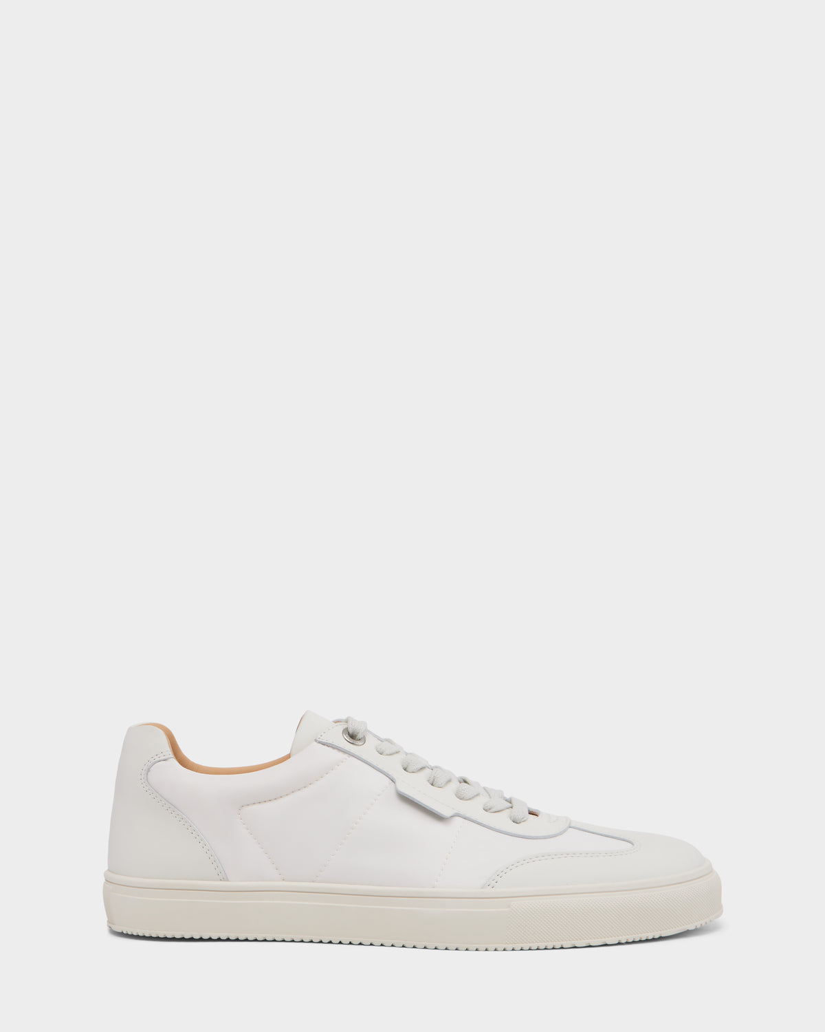The SKYLER - 6225003 Iceland by Rudsak is a minimalist men’s leather sneaker featuring white laces, a light tan inner lining, and a white rubber sole, shown in side profile against a plain white background. Ideal for comfortable style.