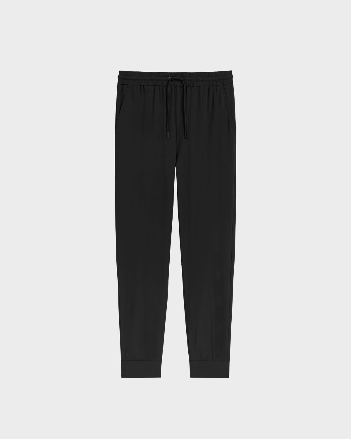 The Rudsak TUSTIN - 6525029 Black jogger pants feature an elastic waistband, drawstring, side pockets, and cuffed ankles for a tailored fit—ideal for mens casual wear. Shown on a plain white background.